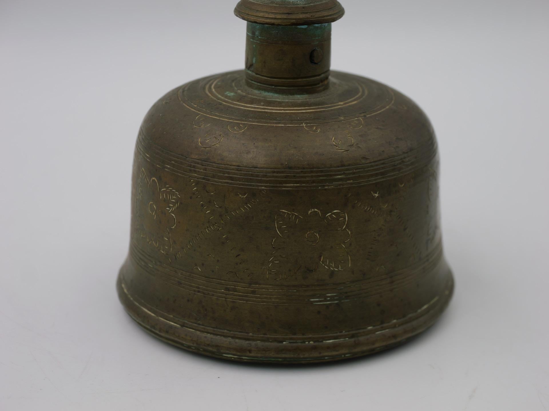 This Antique Indonesian brass bell holds a significant place in ceremonial practices conducted by priests. Crafted with meticulous detail, this bell showcases the traditional artistry of Indonesian craftsmanship. Made from aged brass, it emits a