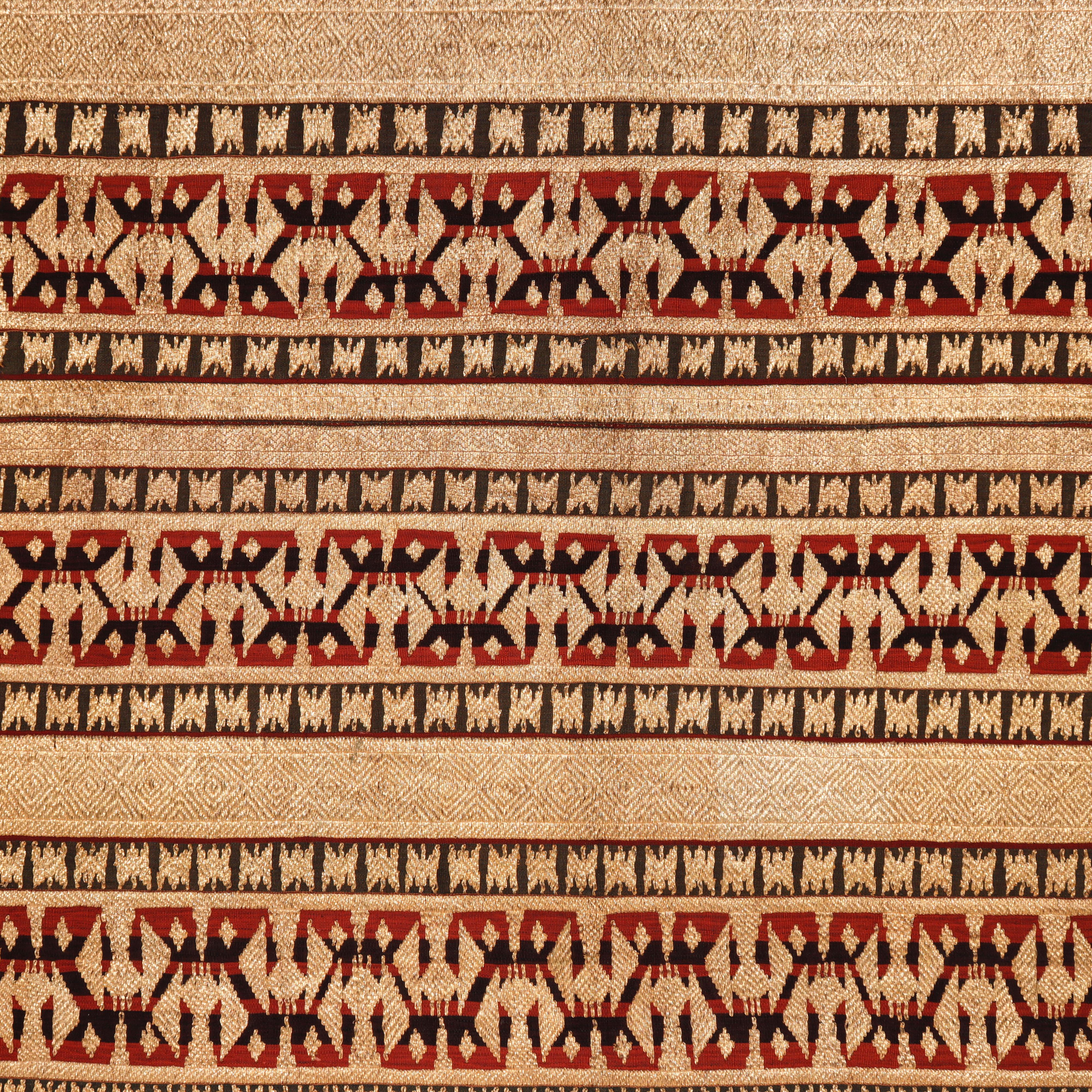 Antique Indonesian ceremonial skirt (Tapis) from the Abung people of Lampung, Sumatra with dense linear abstract design of gold wrapped thread couched down to the multicolored linear background. Skirt seam opened, minor signs of wear, otherwise fine