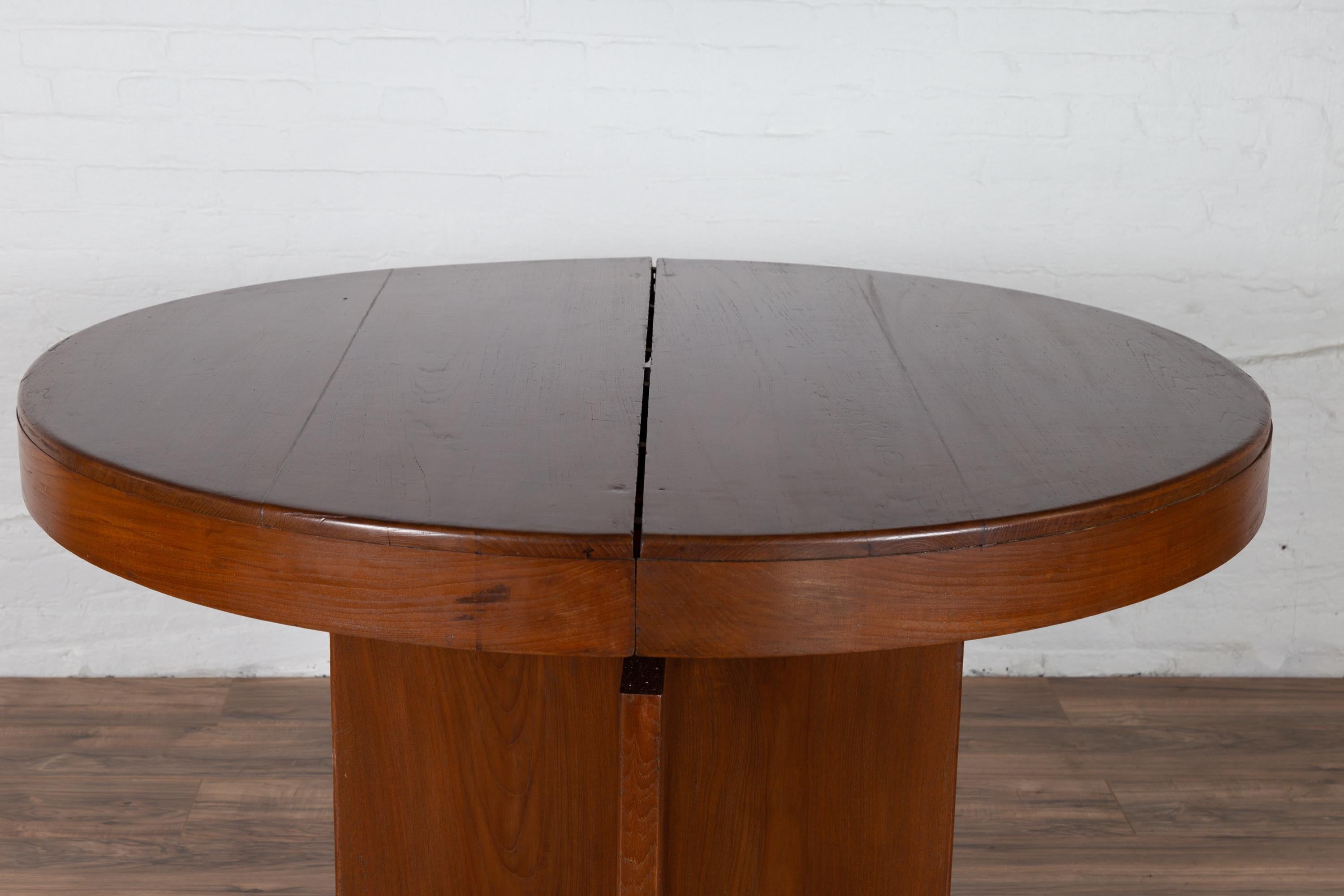 20th Century Antique Indonesian Dining Table with Central Folding Leaf and Geometric Base