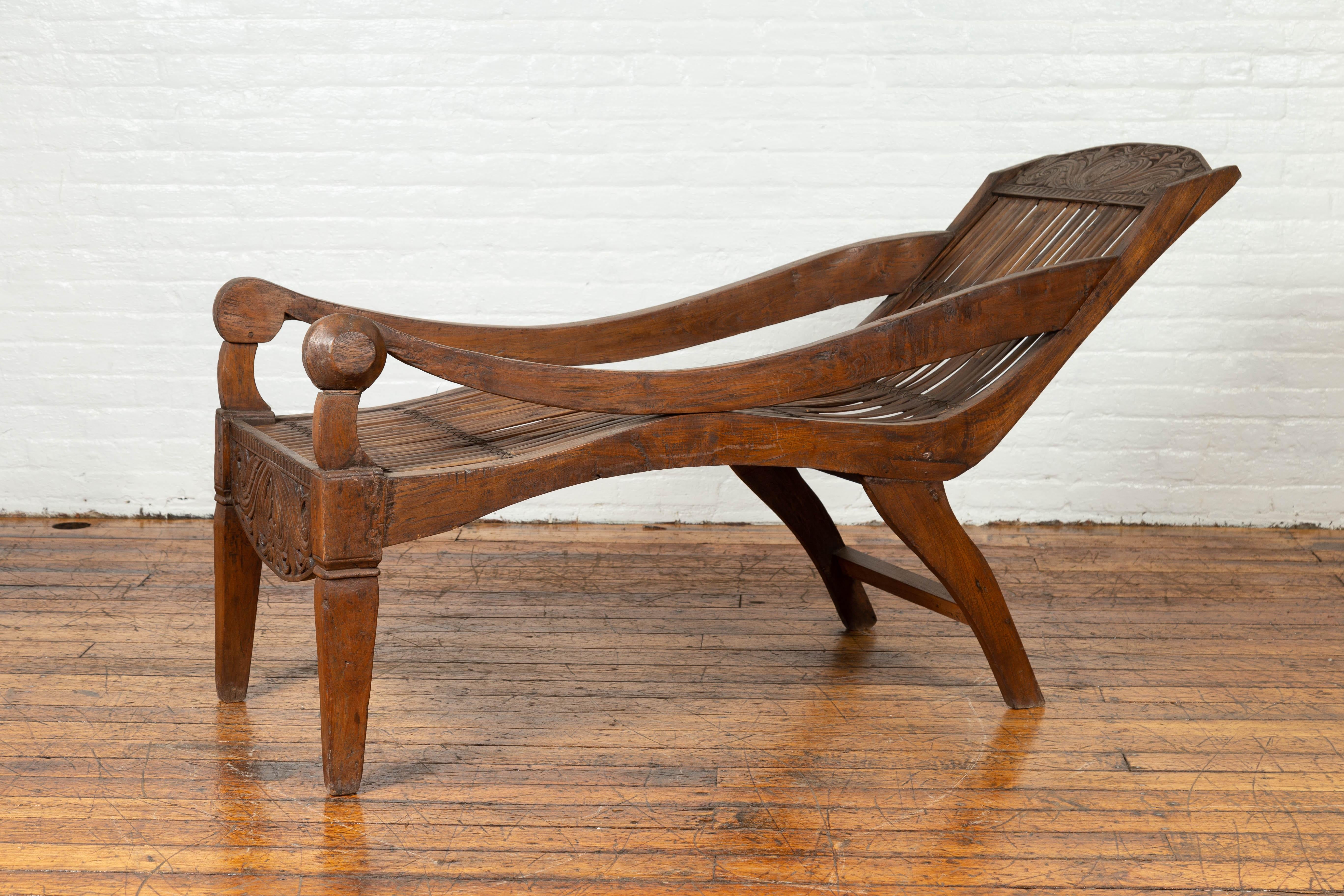 Antique Indonesian Reclining Plantation Chair with Bamboo Slats and Carved Décor For Sale 3