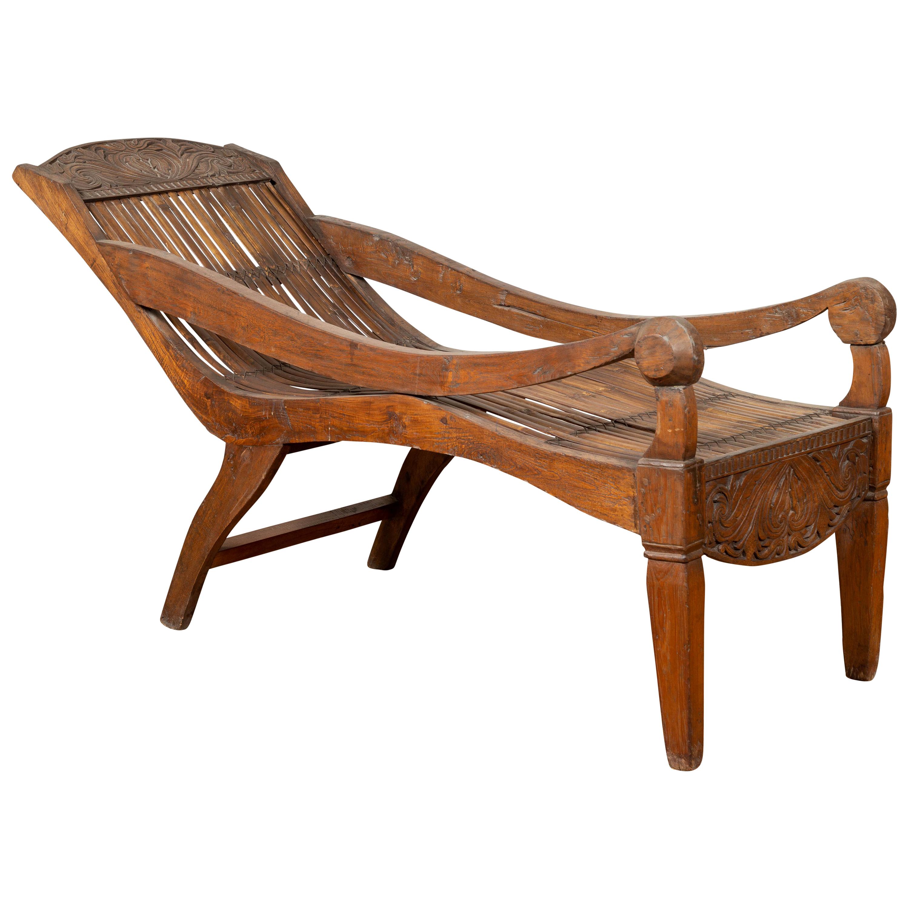Antique Indonesian Reclining Plantation Chair with Bamboo Slats and Carved Décor For Sale