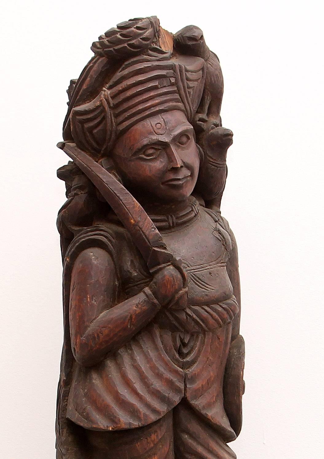 Exotic carved teak sculpture. The sentinel with his sword drawn. 19th century architectural artifact.