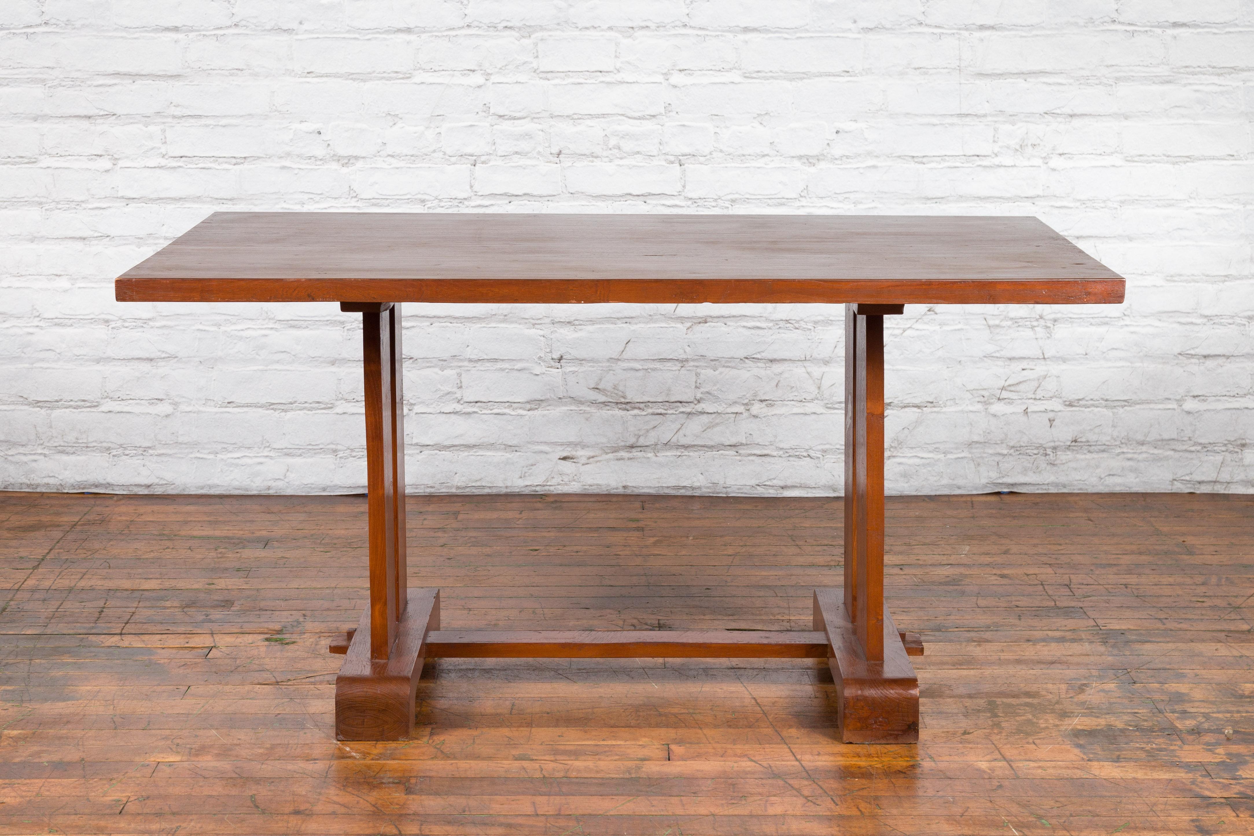 Antique Indonesian Teakwood Dining Table with Trestle Base and Brown Patina In Good Condition For Sale In Yonkers, NY
