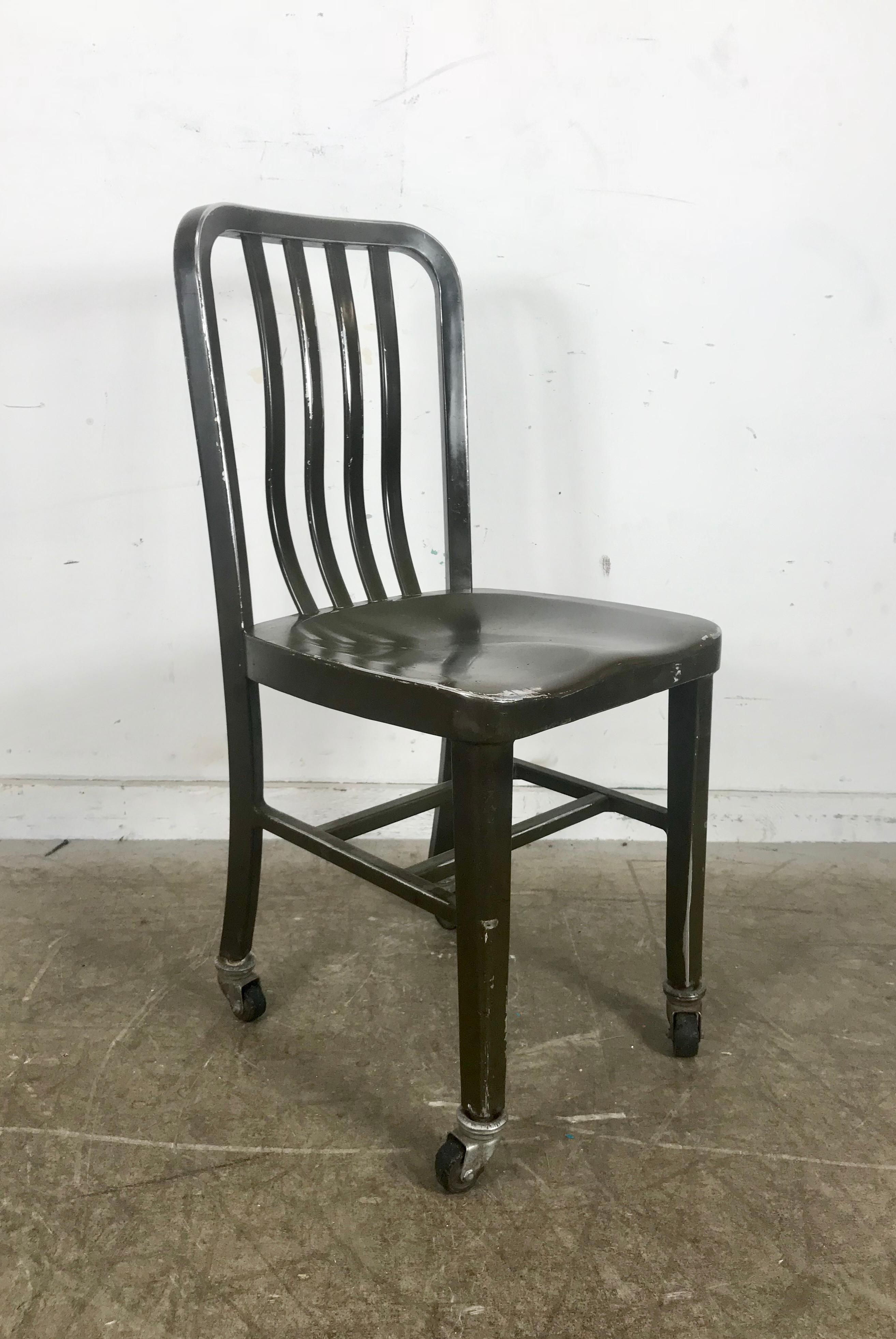 Antique industrial aluminum rolling desk chair by General Fireproofing co. Amazing patina, surface and finish, curved aluminum slat back for optimum comfort, retains original painted greenish brown finish as well as aluminum and rubber wheels,.