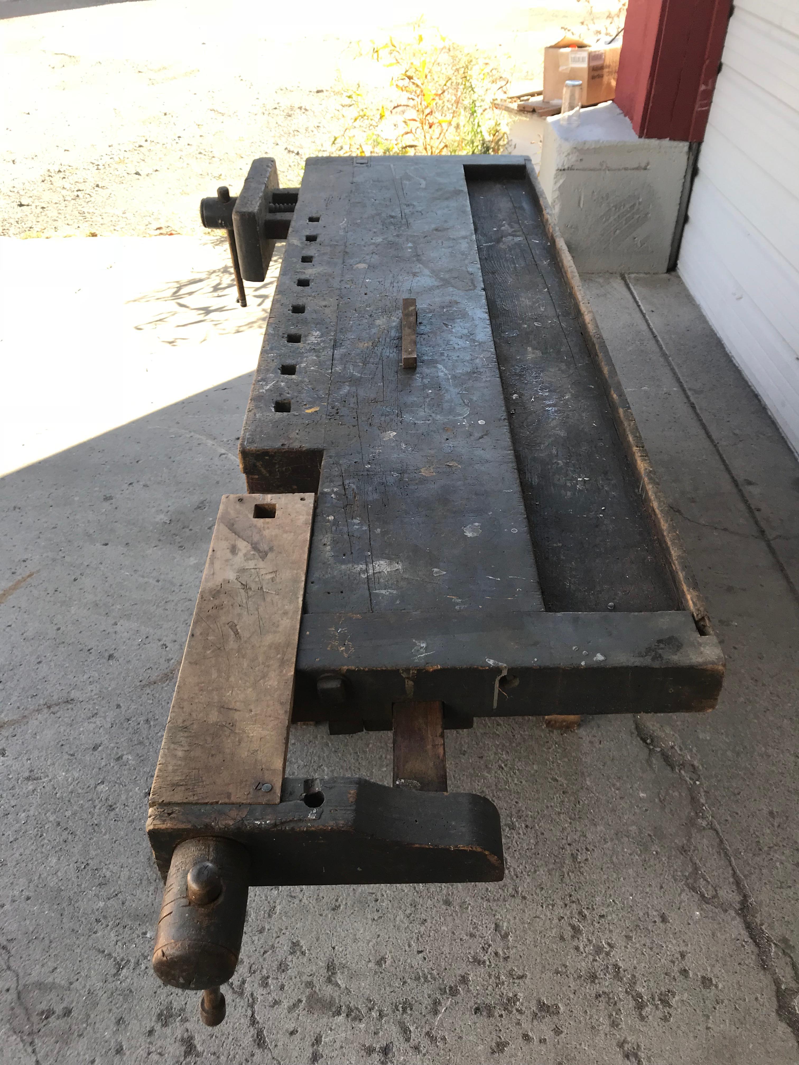 Antique industrial carpenters workbench, 2 vises, 2 drawers. Amazing patina, an interesting and well used craftsman's work bench from early 20th century, Hand delivery avail to New York City or anywhere en route from Buffalo NY.