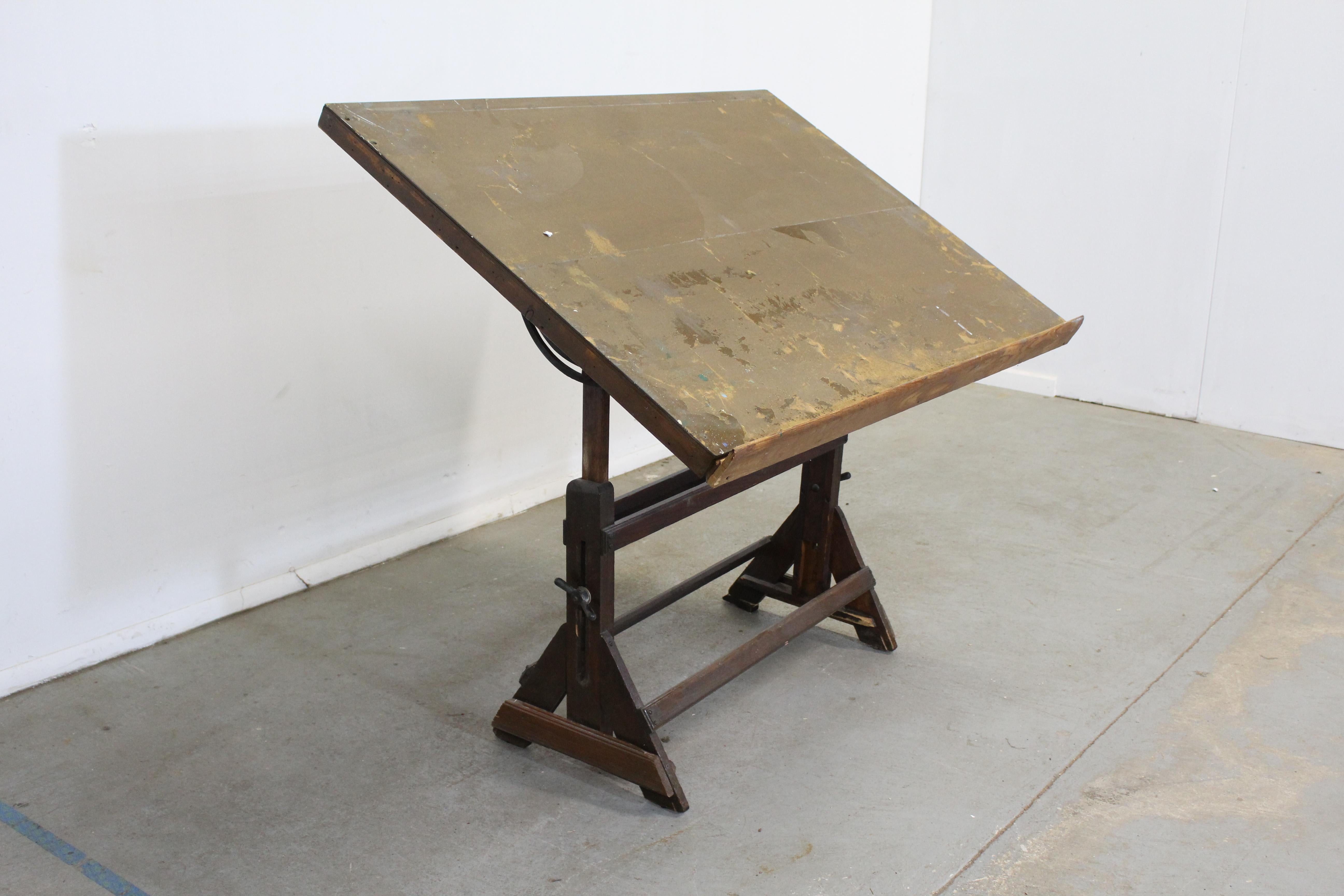 Antique drafting table with adjustable top

What a find. Offered is an antique drafting table that is estimated early 1900's. The top is adjustable to tilt to your liking. It is in vintage condition with minor surface wear/chips. It is