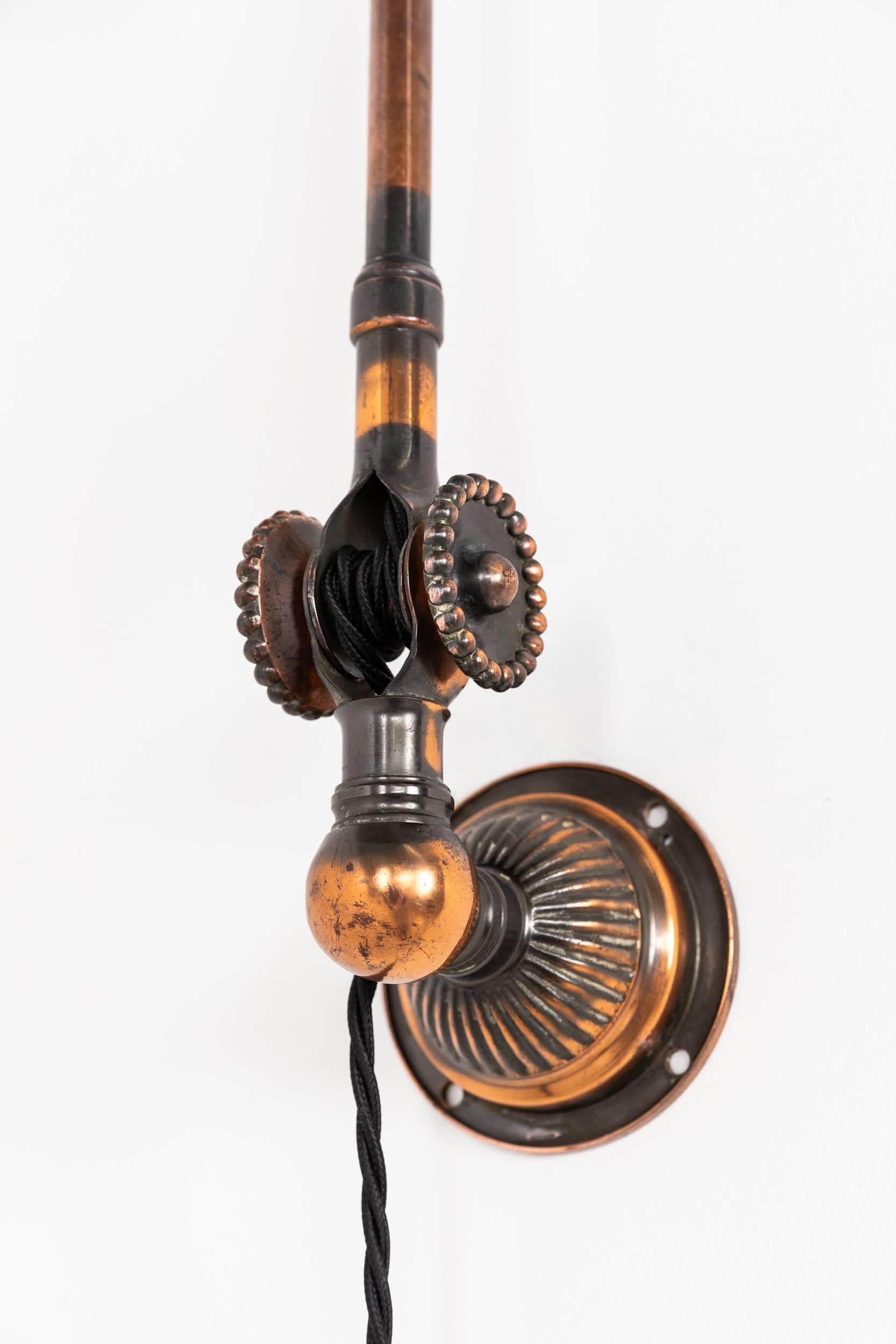 Very rare example of the iconic factory machinist’s lamp, made in England by Dugdills, c.1910.

Crafted entirely from brass with the less commonly seen oxidised copper finish. Features the classic Dugdills 'rosettes' used to secure the joints in