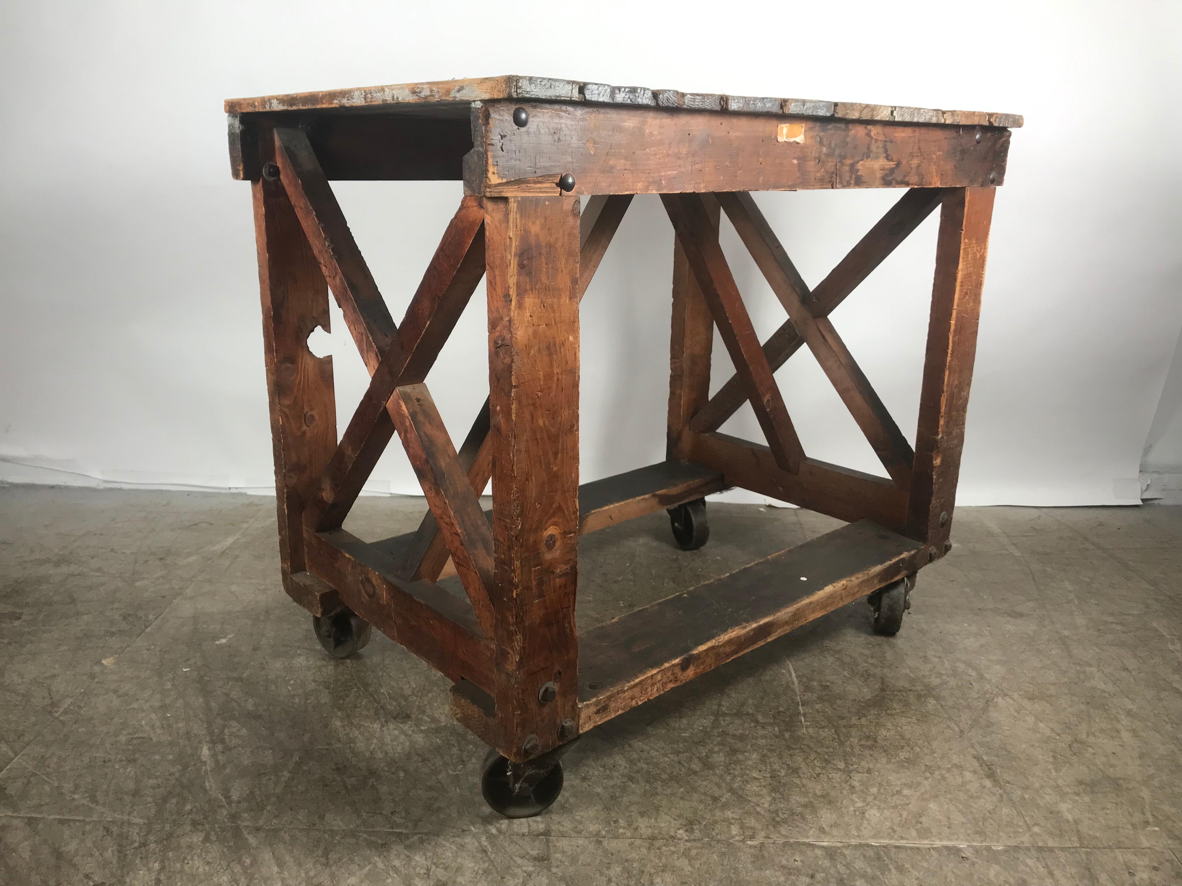 Antique Industrial factory work table on iron castors, simple design, handmade, heavy duty construction, hand delivery avail to New York City or anywhere en route from Buffalo NY.
