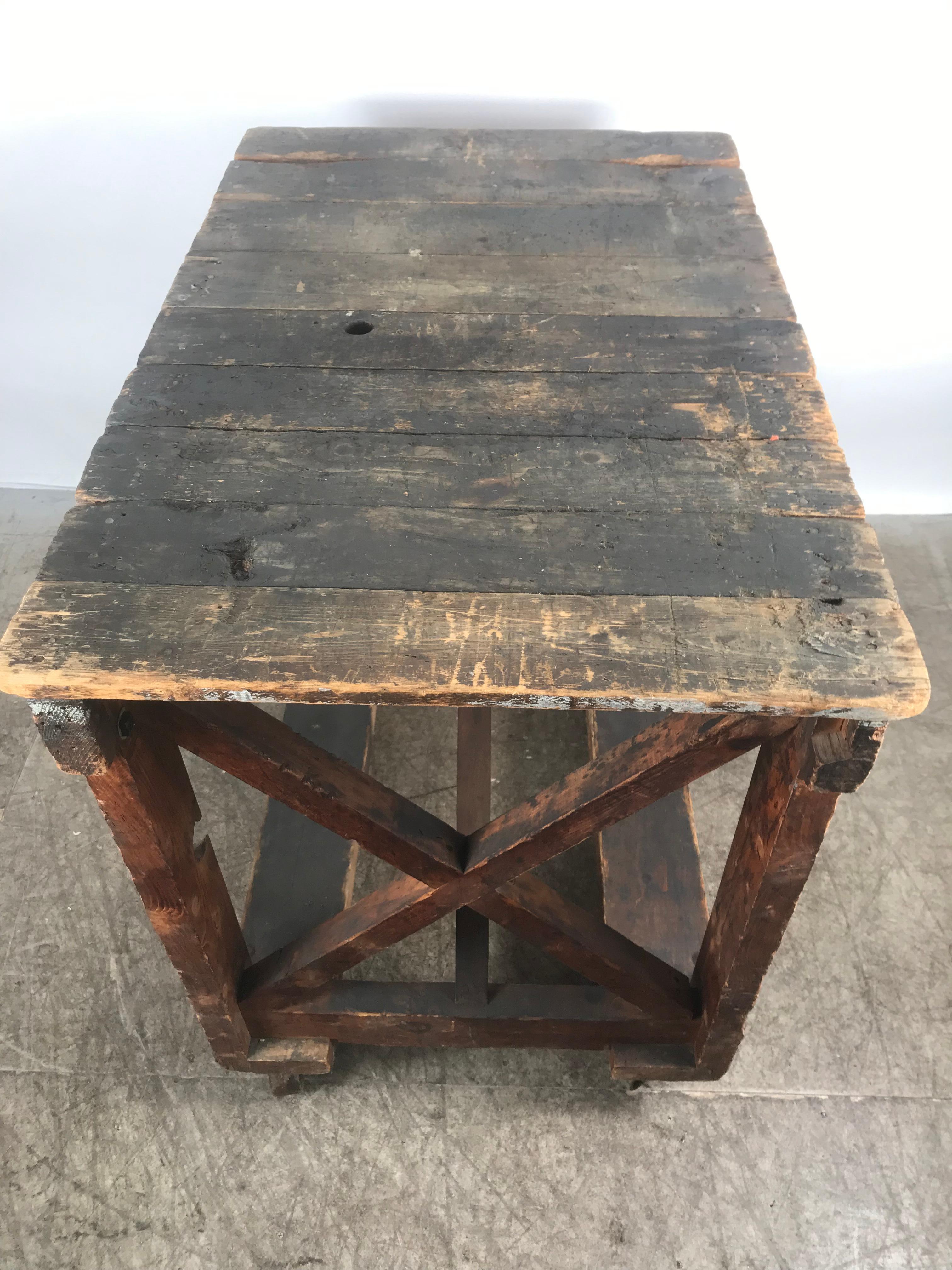 Antique Industrial Factory Work Table on Iron Castors In Distressed Condition For Sale In Buffalo, NY