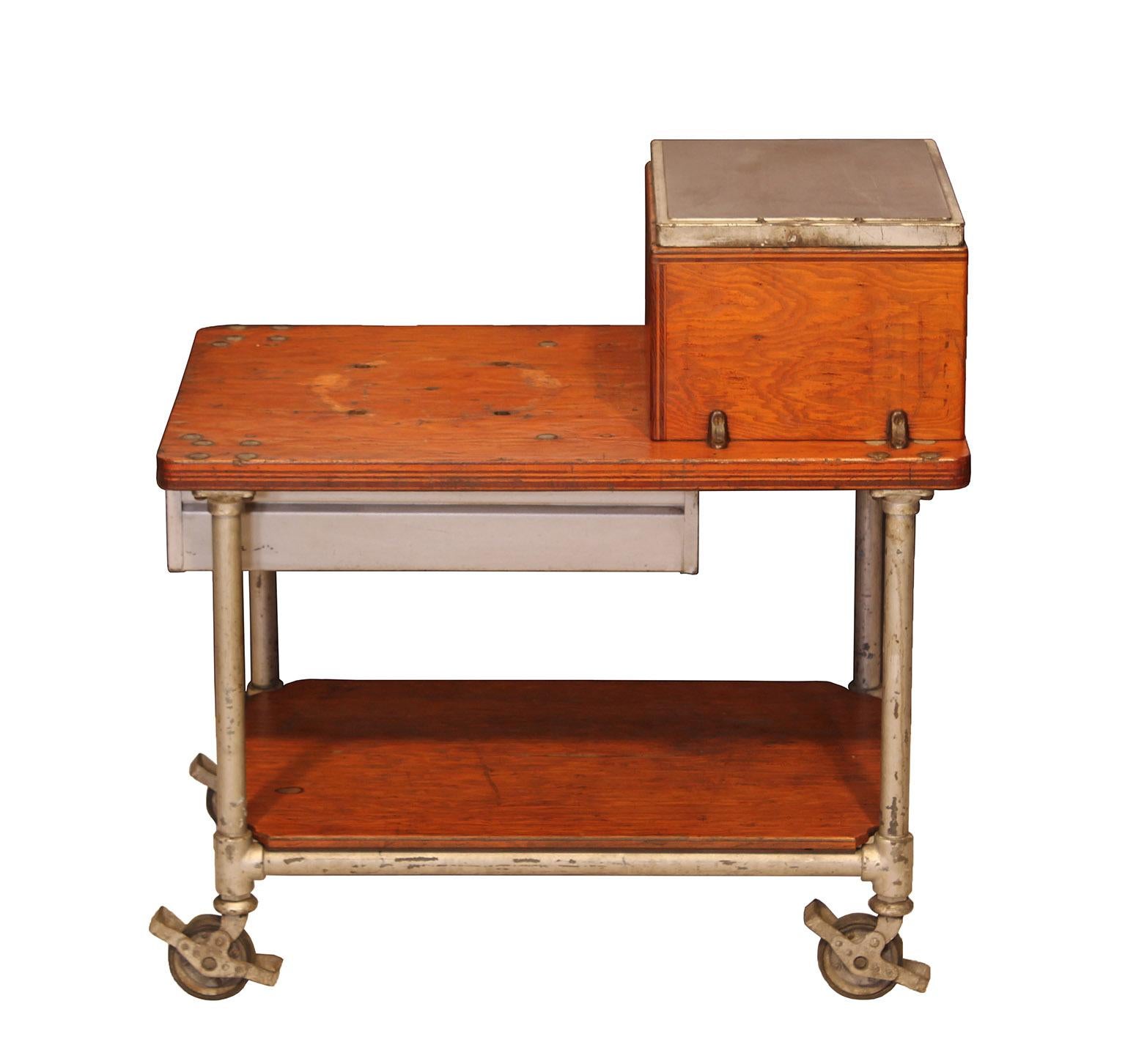 Vintage American industrial factory cart with 2 drawers and a cast-iron work surface. Made with pipe legs, frame and lockable casters. 

Dimensions: overall width 36