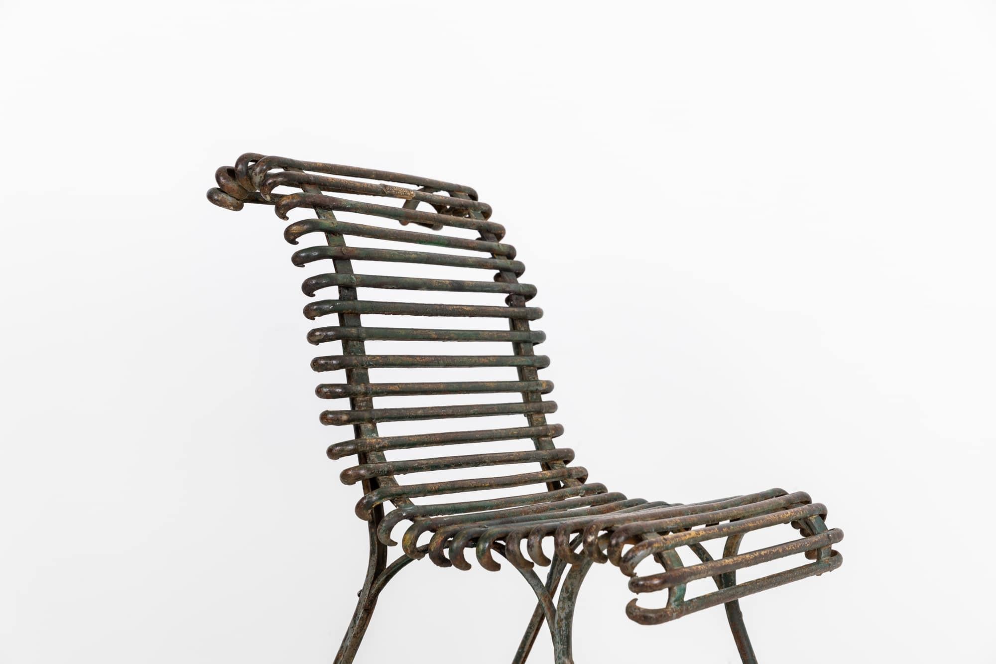 

A beautifully aged wrought iron garden chair from the Arras region in France. c.1900

Presented in original as found condition with a wonderful patina all over and bags of character. Blacksmith made and hand rivetted with pad feet all intact