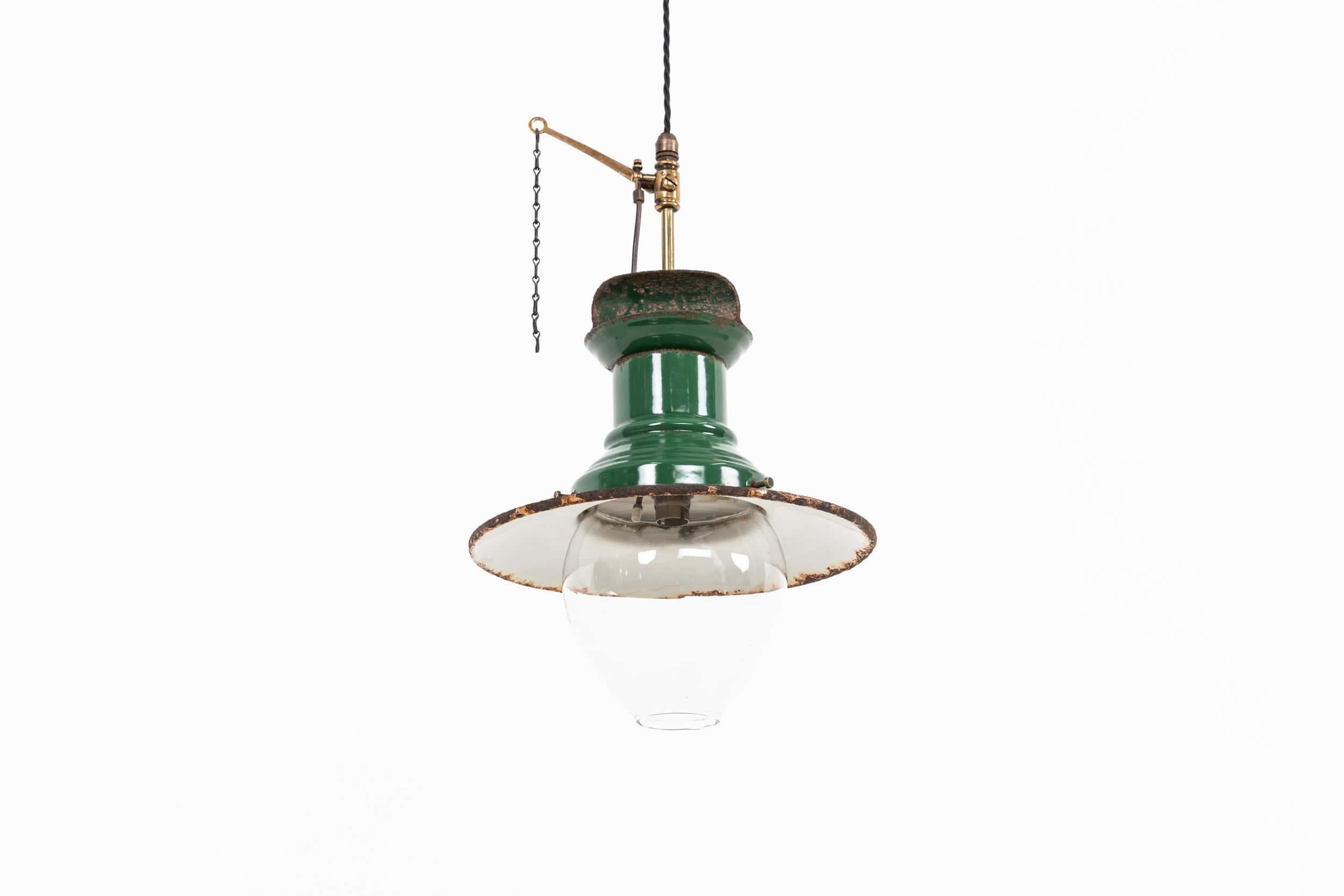 A beautiful English enamel railway pendant light made by Sugg. c.1900

A former gas lamp often used on railway platforms from the late 19th/early 20th century. Simple two-part enamel gallery with the original glass hand-blown bowl beneath (which