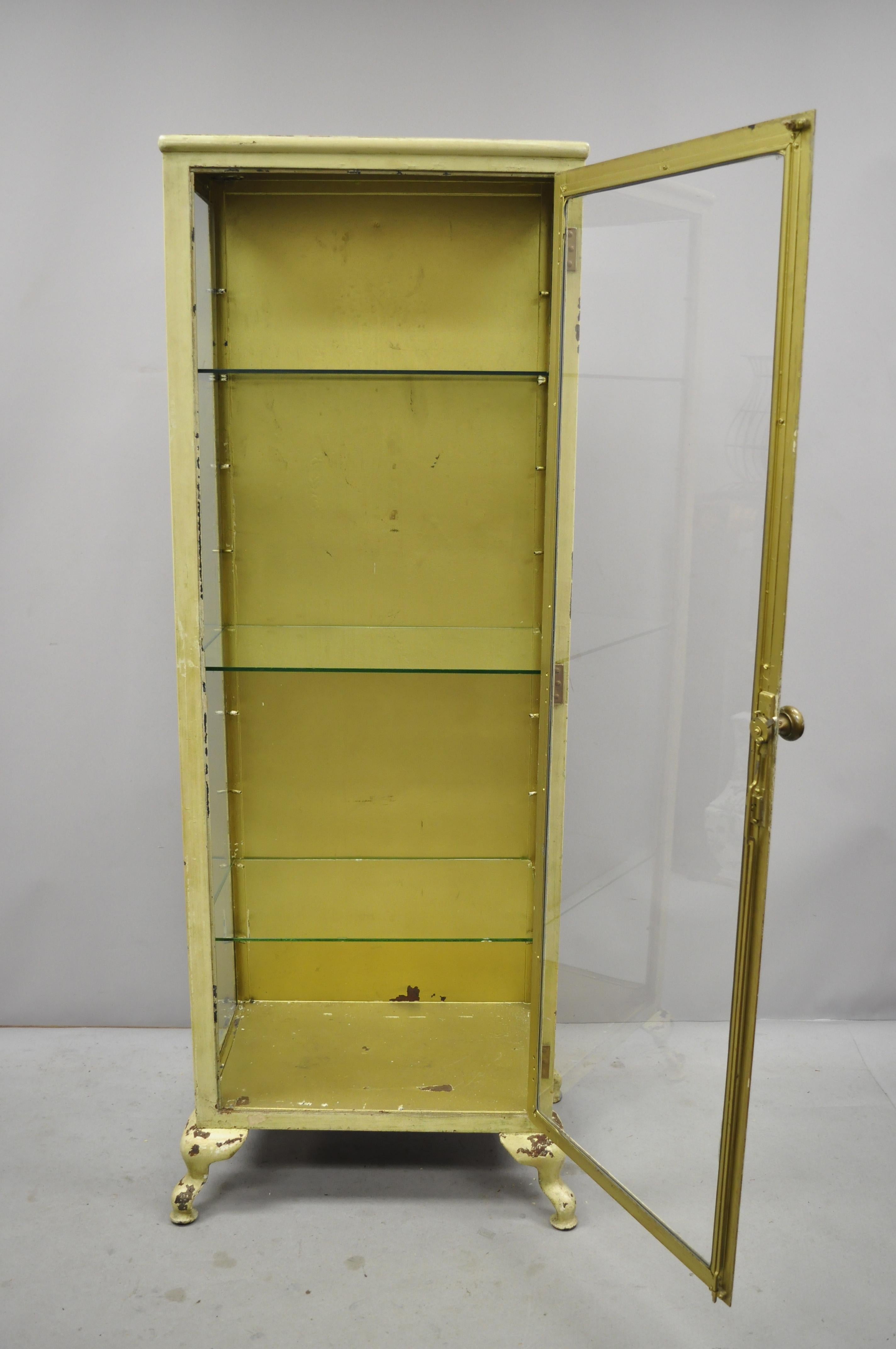 Antique industrial steel metal and glass medical storage dental tall bathroom cabinet. Item includes a glass front and sides, steel metal frame, 2 part construction, no key, but unlocked, 3 adjustable glass shelves, quality American craftsmanship.