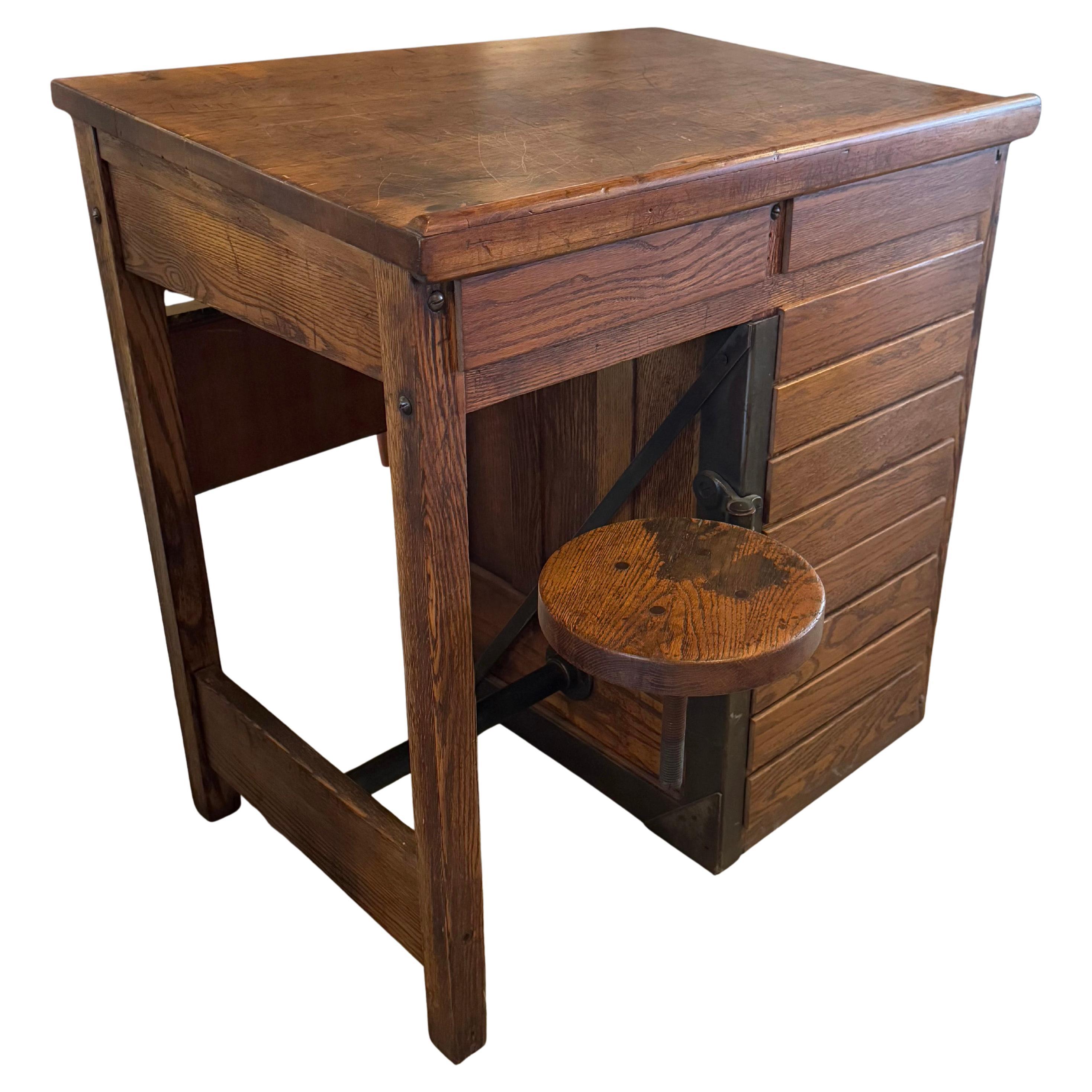 Antique Industrial Oak Wood Typesetter Desk With Swing-Out Seat For Sale