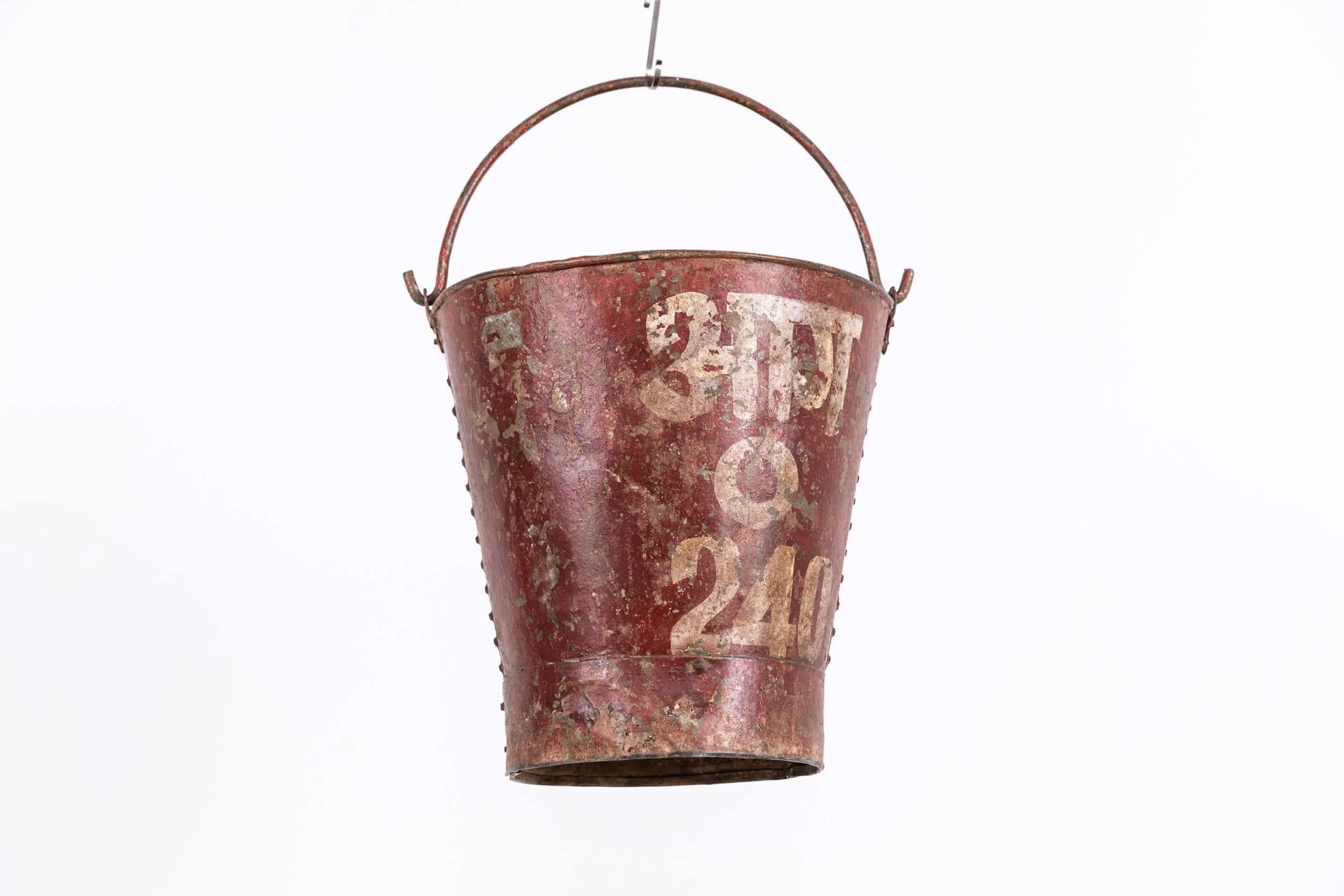 

Very charming red fire bucket with hand painted lettering. c.1920

Really nice example - the colour, patination and style are perfect with hand painted lettering and riveted construction. Embossed with BP (British Petroleum). Perfect for use as