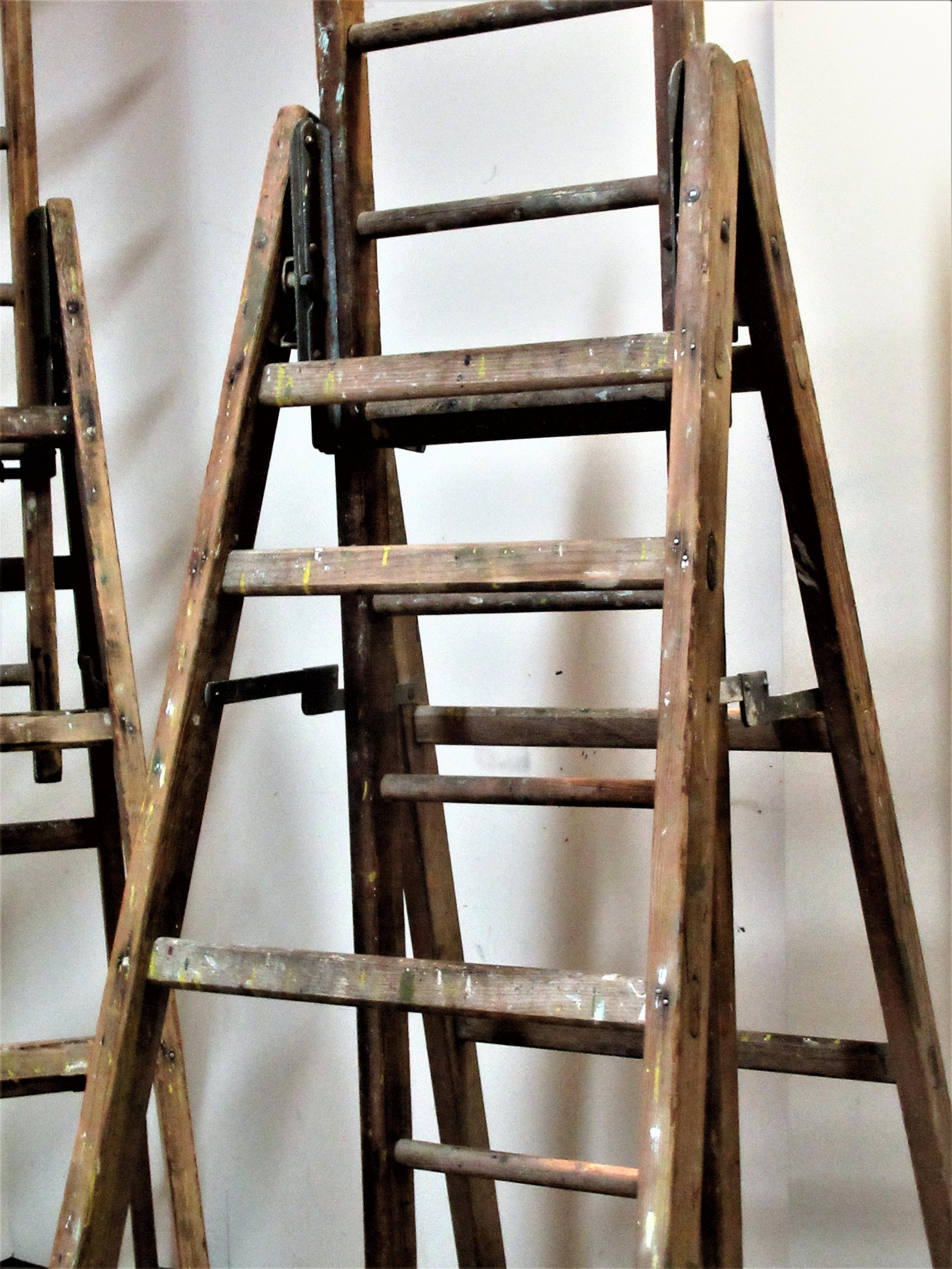 Two old American made wood and steel industrial extension ladders with riveted and mortised construction. Height to top rung when not extended is 66 inches - see picture 9 / height to top rung at fully extended height is 120 inches. There is a steel