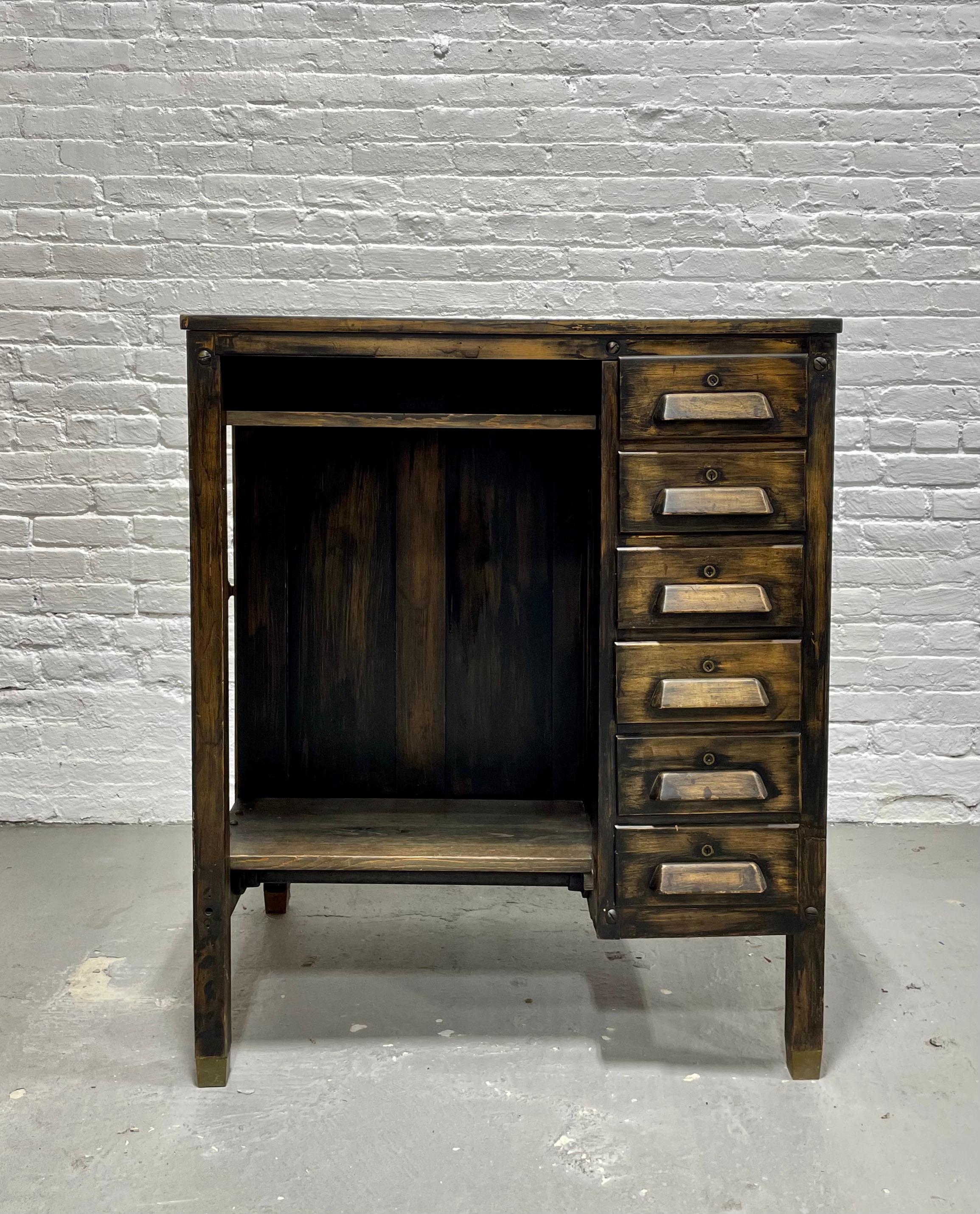 Antique Industrial Wooden Workbench, c. 1920’s. This cabinet features 6 felt lined and dovetailed drawers, a spacious surface area and a side door with additional storage. This piece was likely a Jeweler’s or Watchmaker’s workbench but would make a