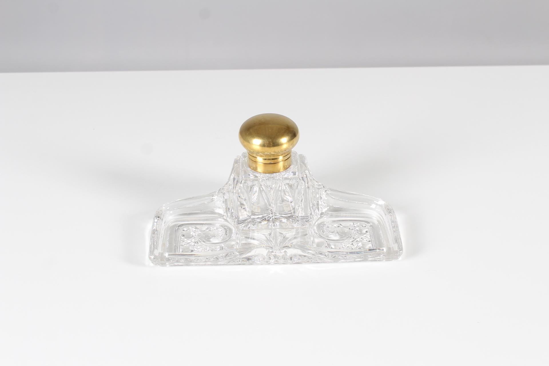 Exceptional inkwell with pen tray made of BACCARAT crystal. The rectangular pen tray has a cube-shaped inkwell holder in the center, closed with a gilded brass hinge. There is a relief mark BACCARAT DEPOSE on the inside.

Baccarat is a French city