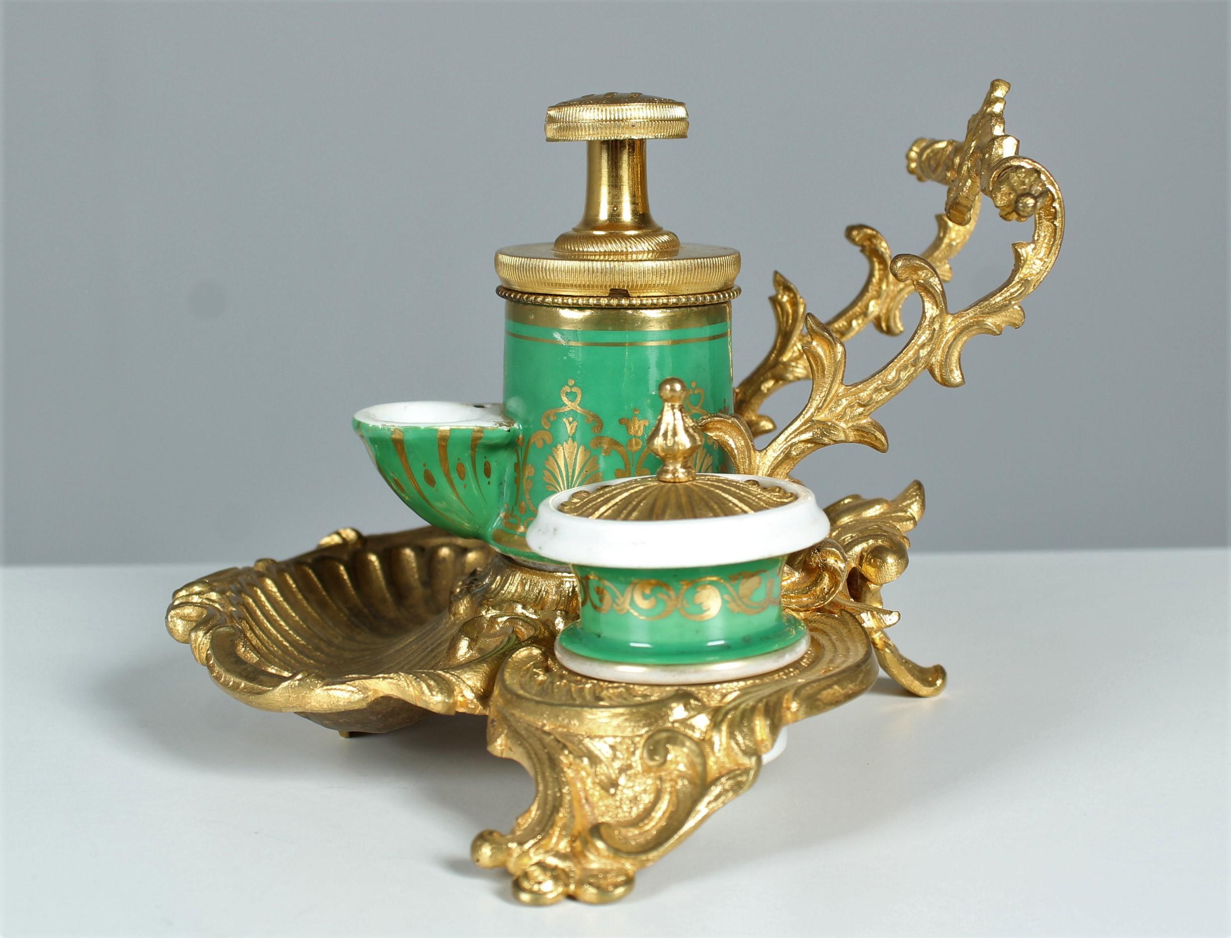 Exceptional antique Inkwell with rich bronze ornaments and three ceramic vessels.
The ink jars are painted in a beautiful rich green and embellished with gold colour.
France, circa 1880.




