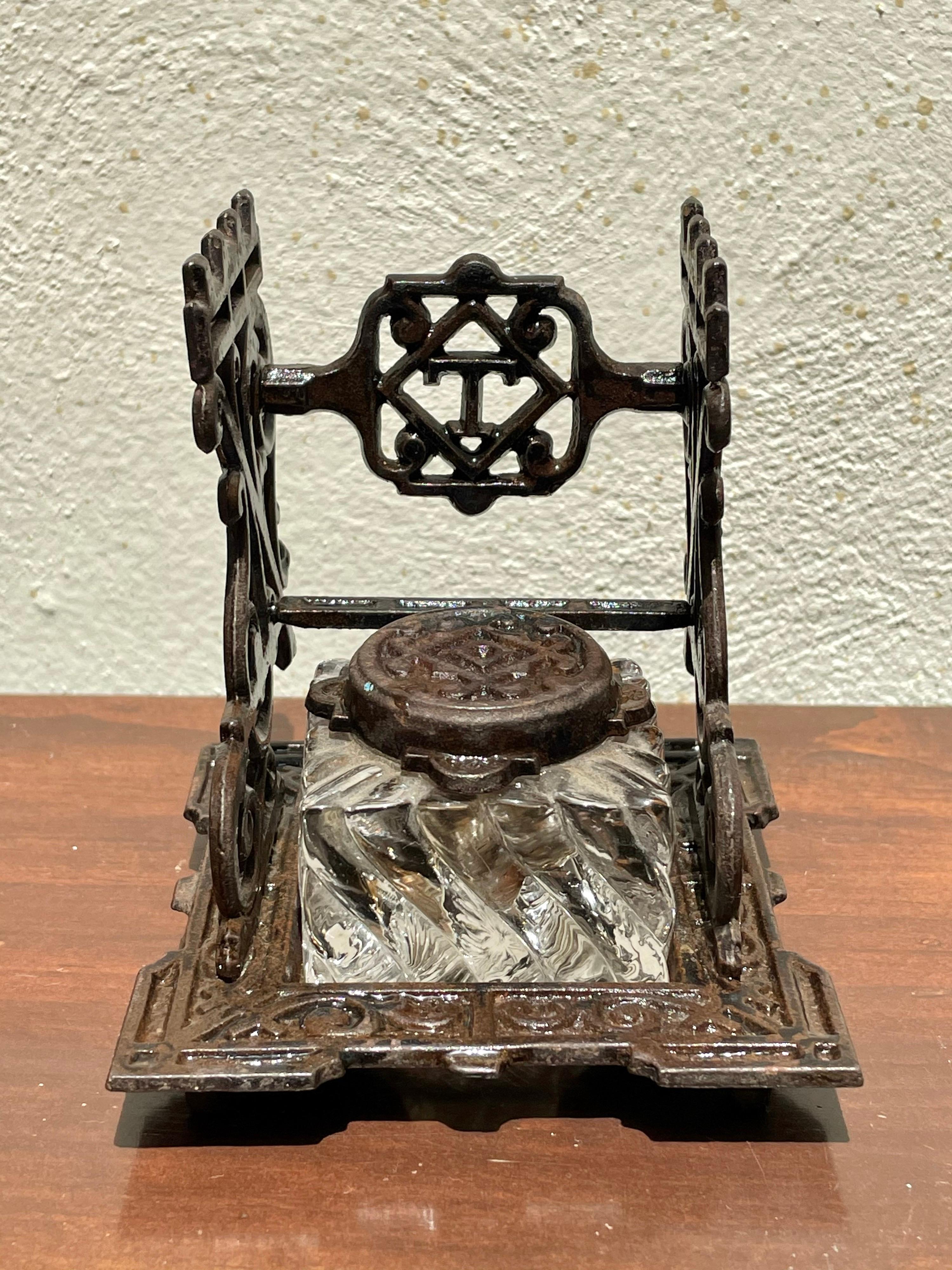 Antique Ink Well Tatum’s Standard, crystal well, 3 pen quill rests, hinged lid.

This piece is cast iron and crystal.
It is a beauty!