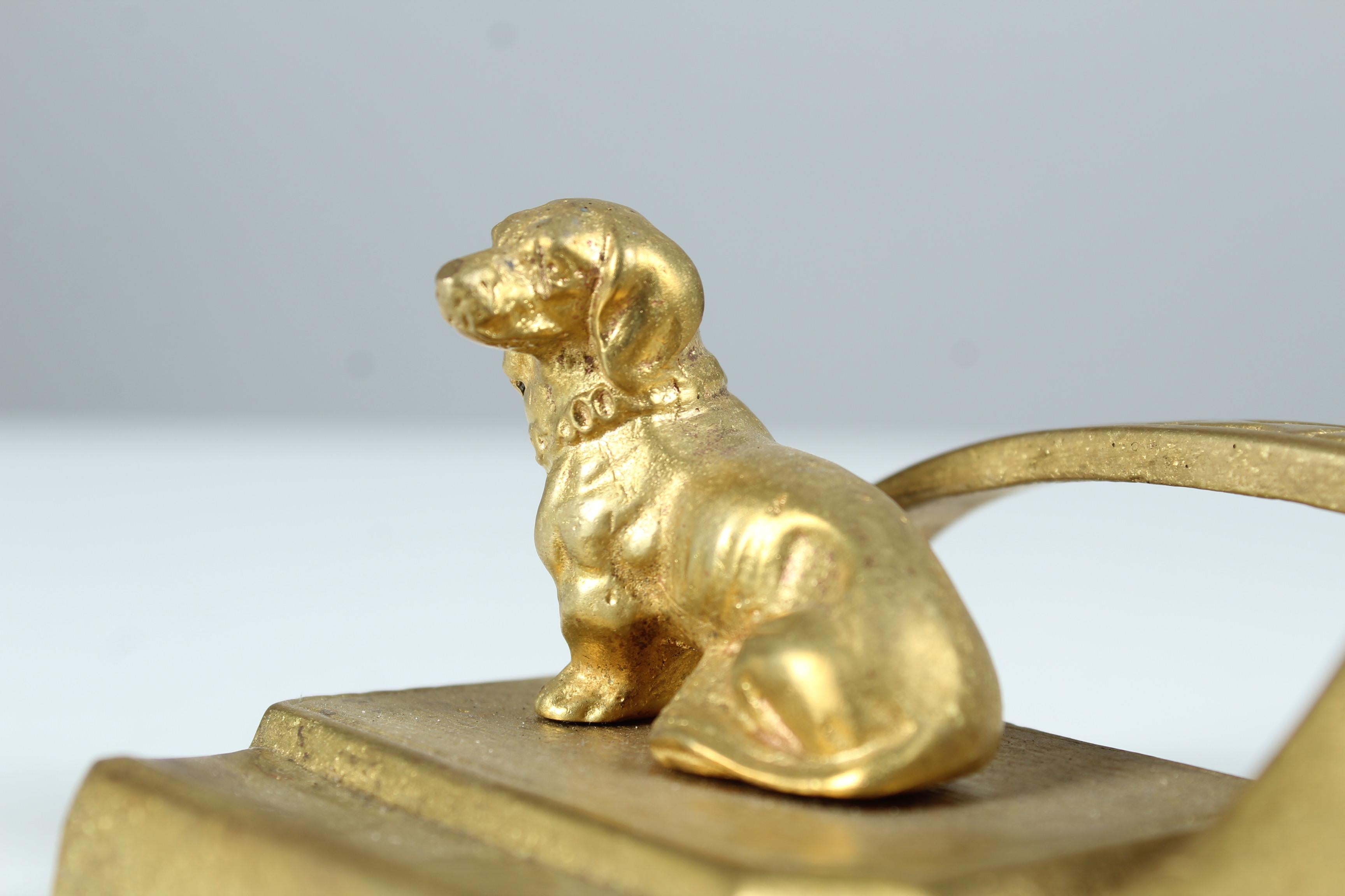 Wonderful inkwell made of heavy brass. 
Beautifully crafted and decorated with a dachshund figure.
France, early 20th century.