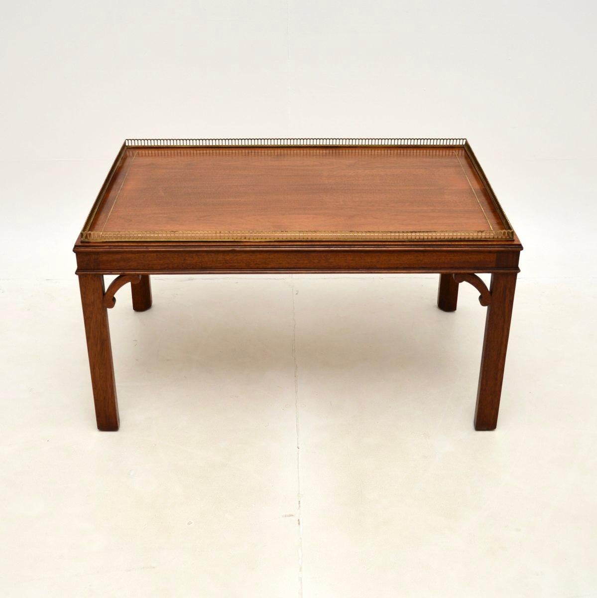 A wonderful antique inlaid brass Chippendale style coffee table, made in England and dating from around the 1930’s.

This is of superb quality and is a very useful size. The top has a pierced brass gallery with lovely details, and an inlaid border