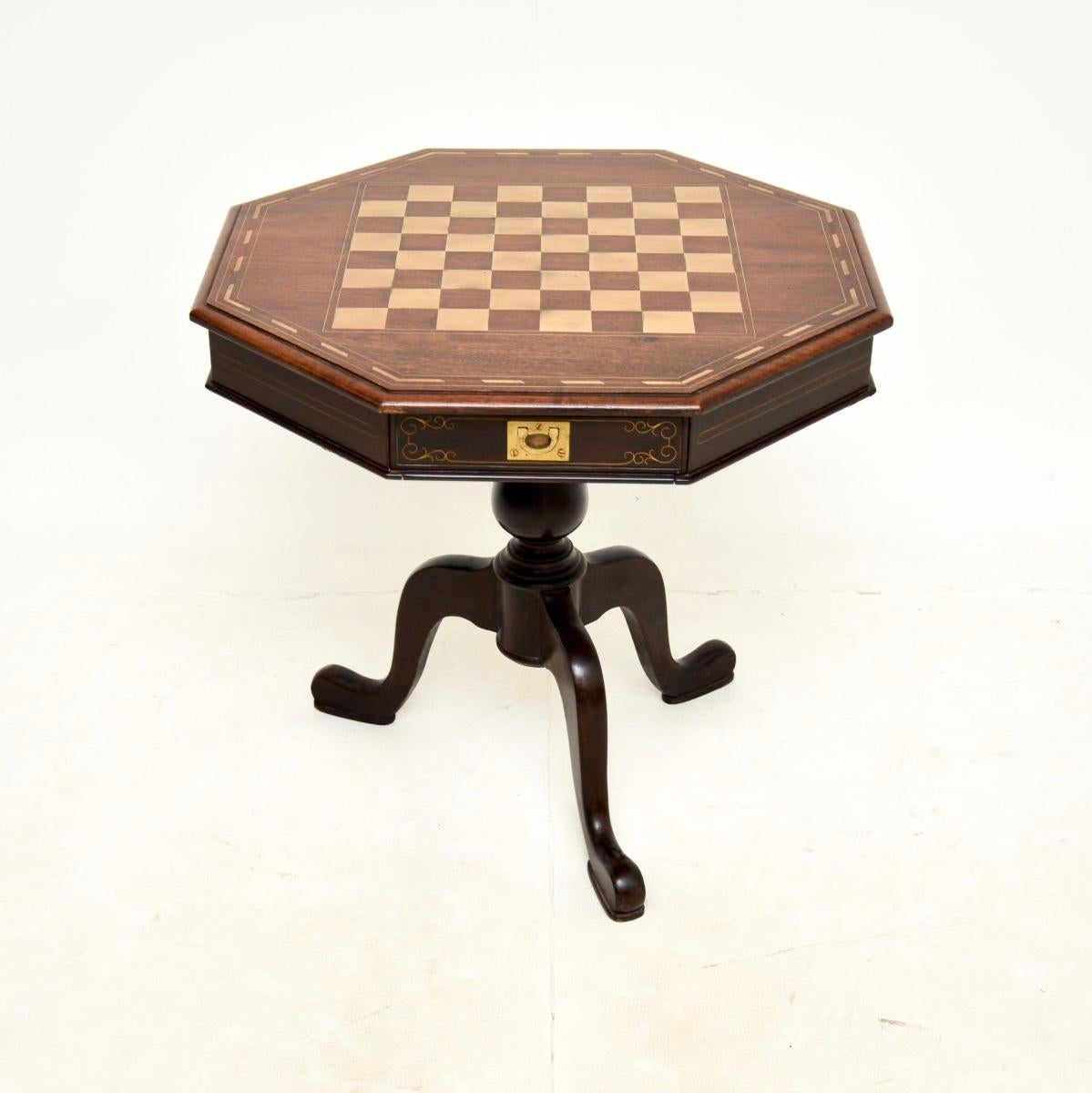A wonderful antique inlaid brass side / chess table. This was made in England, it dates from around the 1950’s.

It is of lovey quality, the top is beautifully inlaid with a brass chessboard and inlaid brass borders. There are two useful drawers on