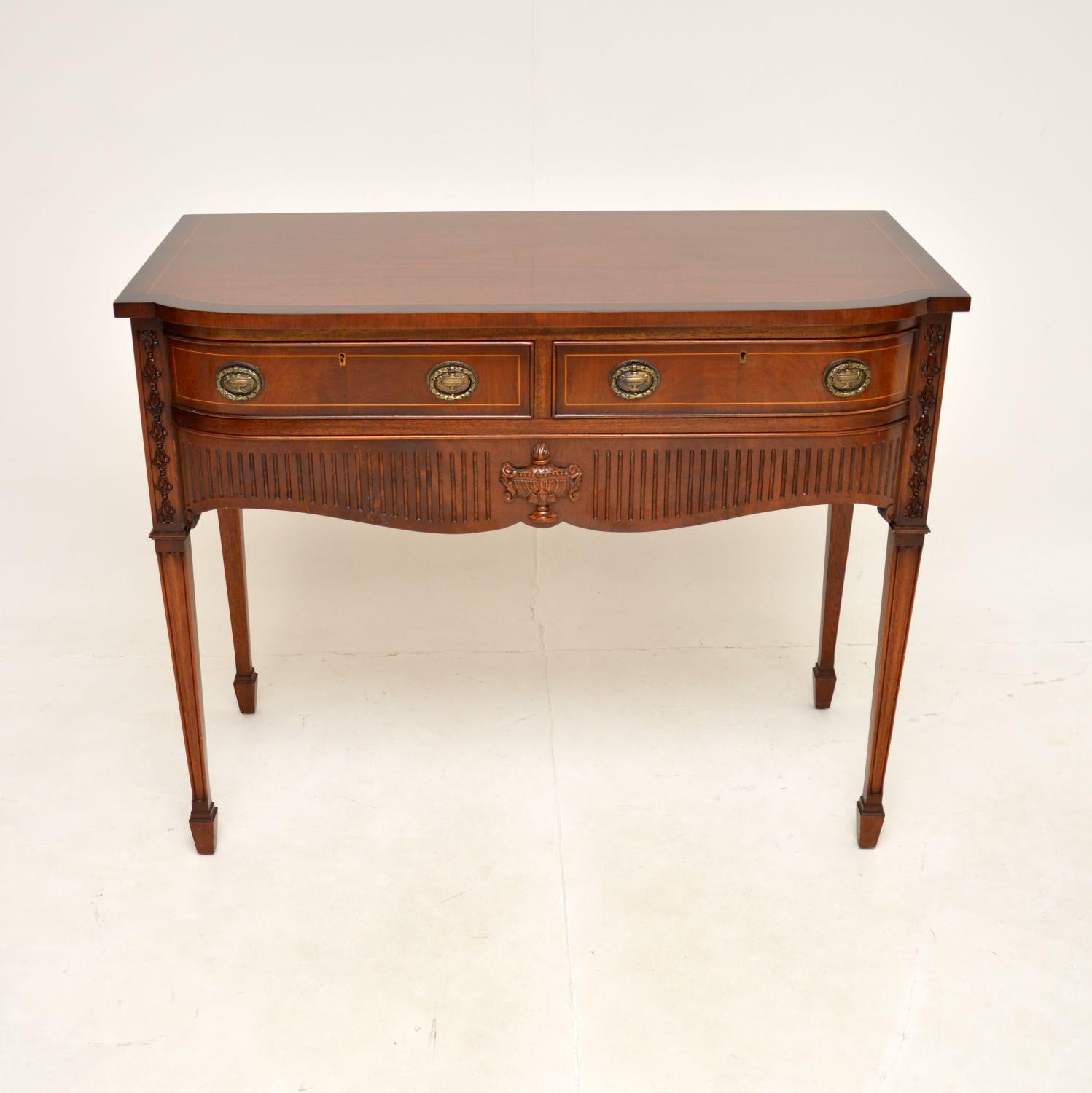 A beautiful antique inlaid console / server table in the Regency style. This was made in England, it dates from the 1950’s.

The quality is outstanding, this is a useful size and has three generous drawers. The drawers are felt lined with cutlery
