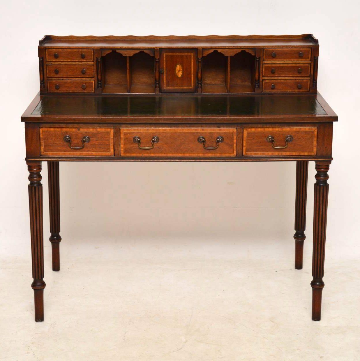 Antique mahogany and satinwood inlaid writing table desk with a useful and decorative back section. This desk is Sheraton style and I would date it to circa 1930s period. The top raised section has two banks of three drawers, four compartments and a
