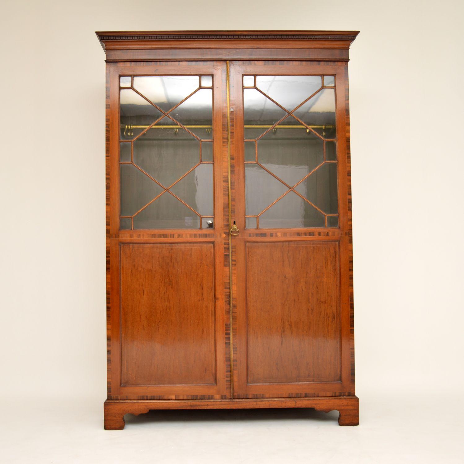 This antique mahogany wardrobe is quite unusual because it has astral-glazing within the doors. The glass looks really old and you can see the ripples and bubbles on it. I think this wardrobe could be Georgian, looking at the construction and glass,
