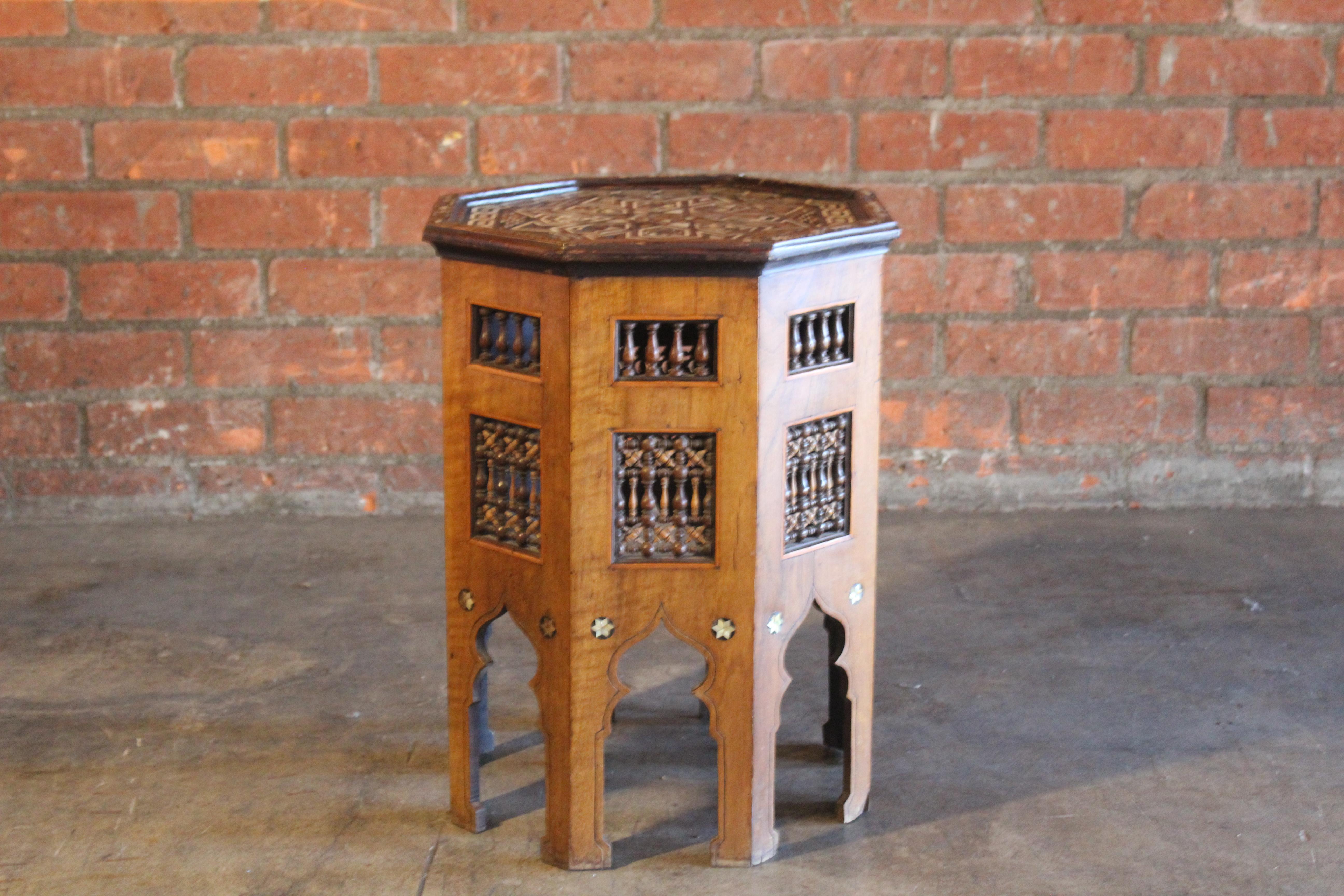 An antique Moorish style inlaid side table with intricate details such as bone, pearl and mixed exotic woods. In good condition with age-appropriate wear and minor losses.