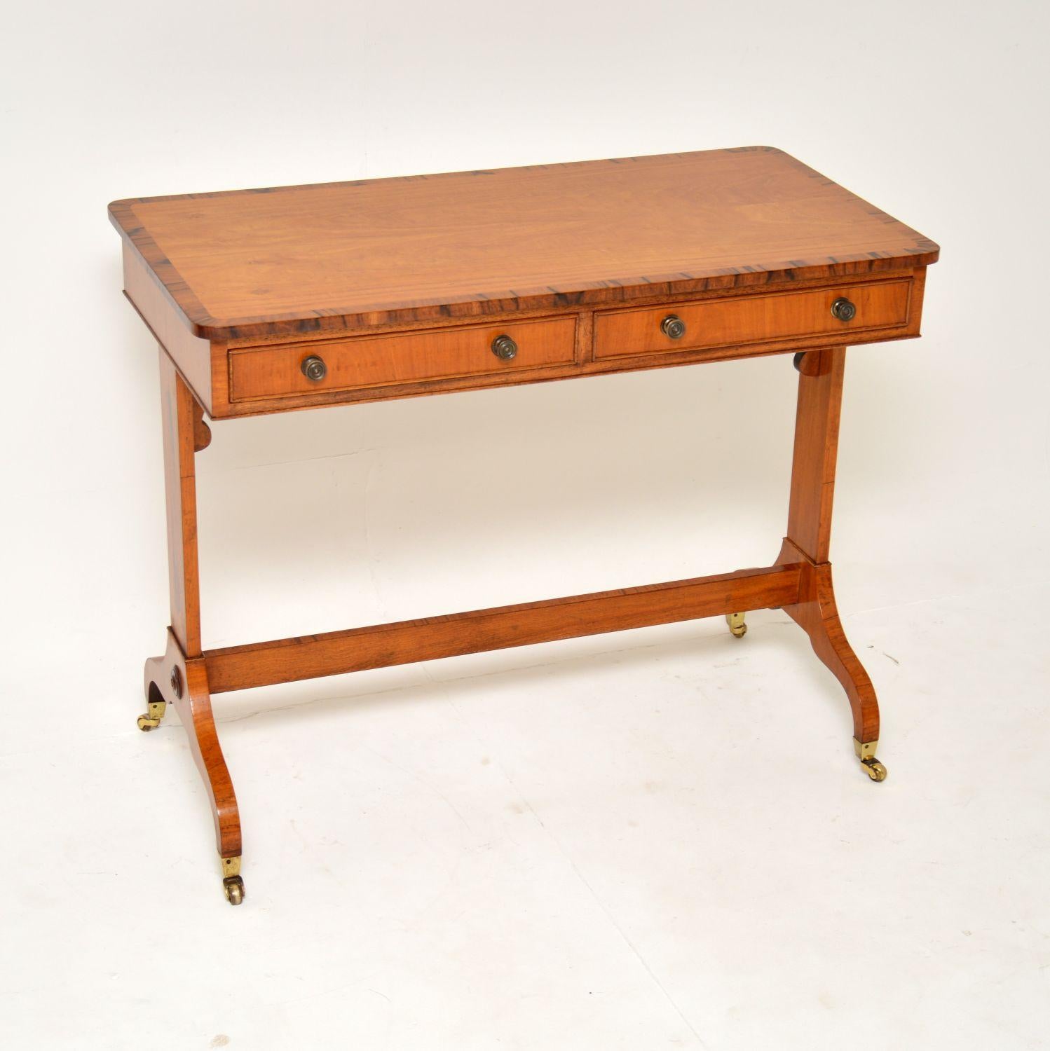 An absolutely stunning antique Regency style writing table in satin wood. This was made in England, it dates from around the 1950’s.

The quality is amazing and this is a lovely size. It has two drawers on the front and two dummy drawers on the