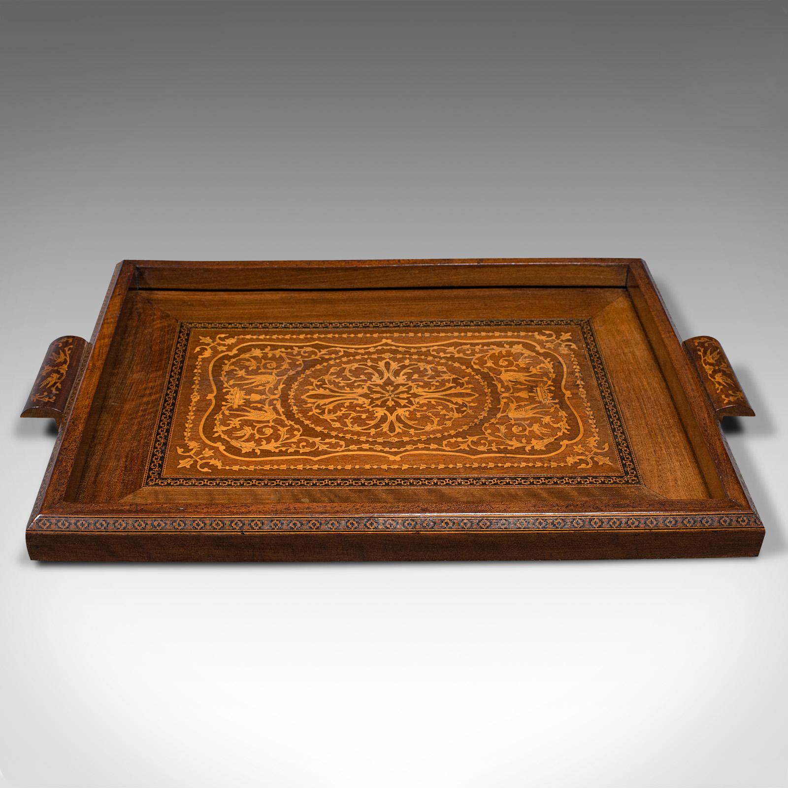 This is an antique inlaid serving tray. An Anglo-Indian, mahogany and boxwood Colonial afternoon tea slide, dating to the late Victorian period, circa 1900.

Enthusiastically inlaid tray with fine decorative appeal
Displays a desirable aged