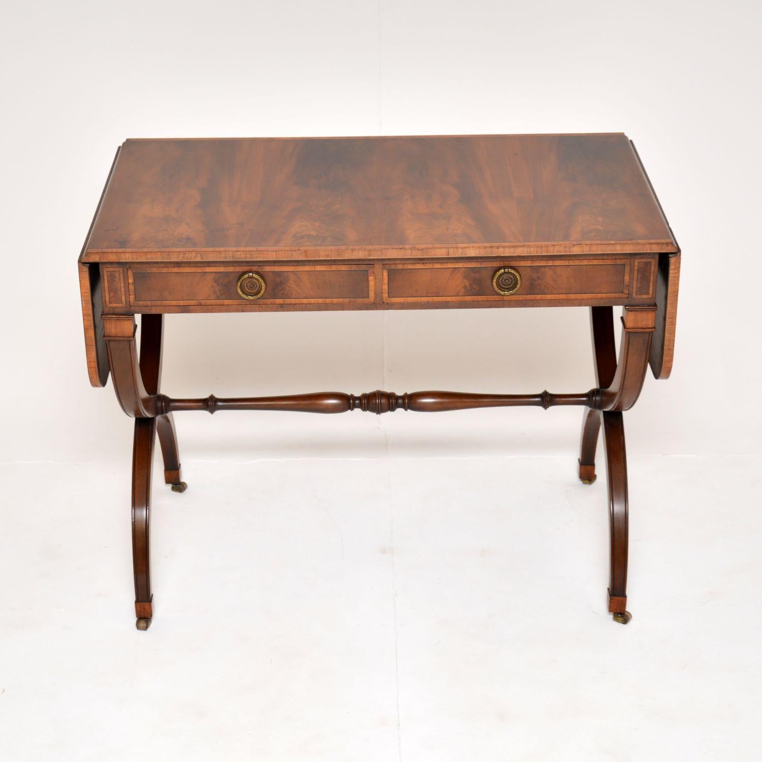 An exceptional antique sofa table in the Regency style. This was made in England, it dates from around the 1920’s.

This is of the utmost quality, the original cabinet makers label is seen inside the drawer. It has an elegant yet sturdy design,