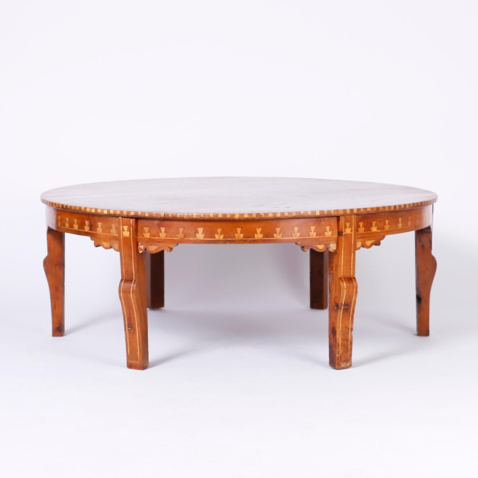 Enchanting Syrian round coffee or cocktail table with elaborate symbolic inlays of kingwood, ebony and mother of pearl, six legs, and an exotic ambiance.