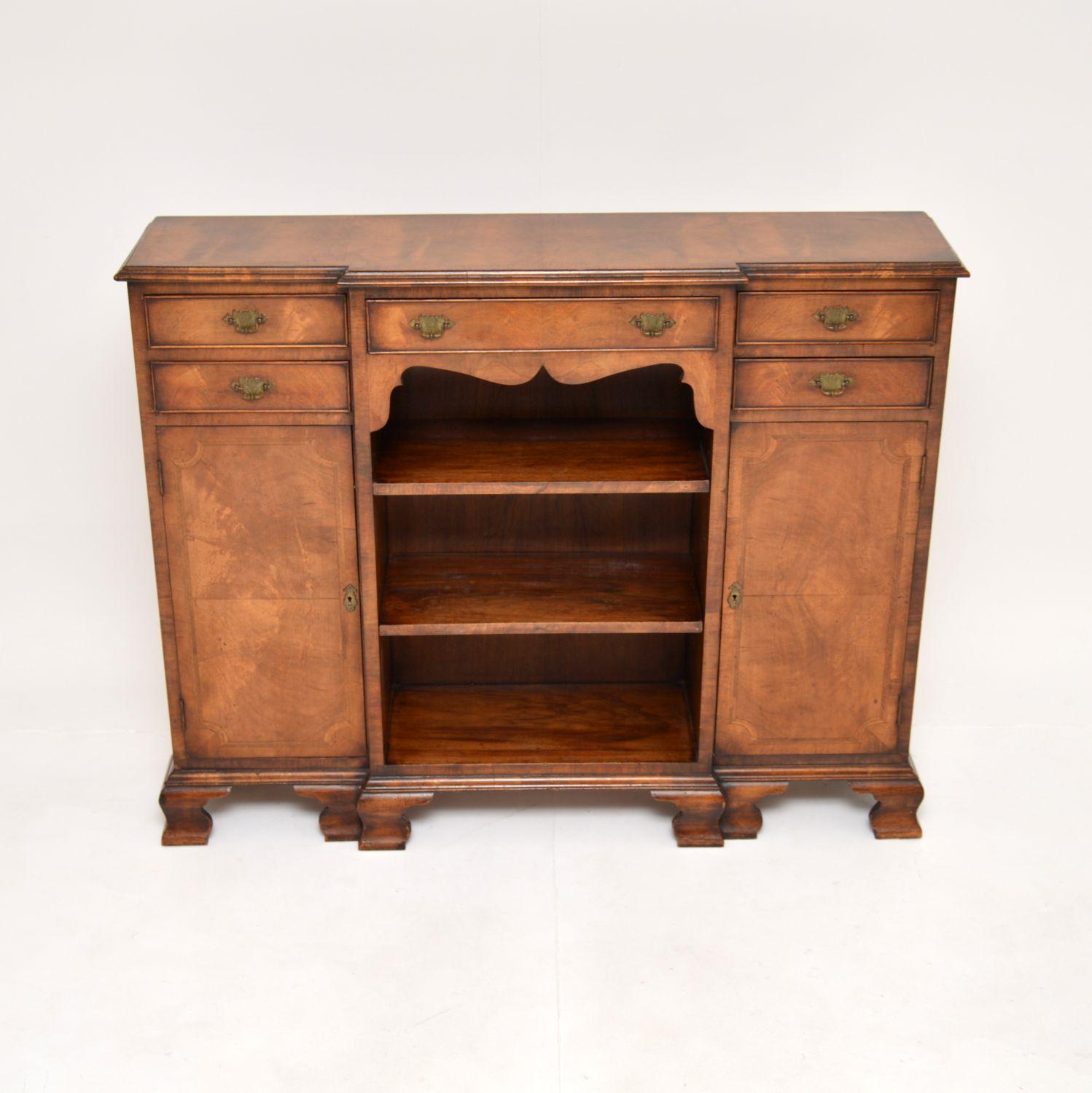 A smart and very well made antique inlaid walnut breakfront bookcase. This was made in England, it dates from around the 1900-1920’s period.

It is of lovely quality and is a very useful size, it is low and slim, yet offering lots of storage space.