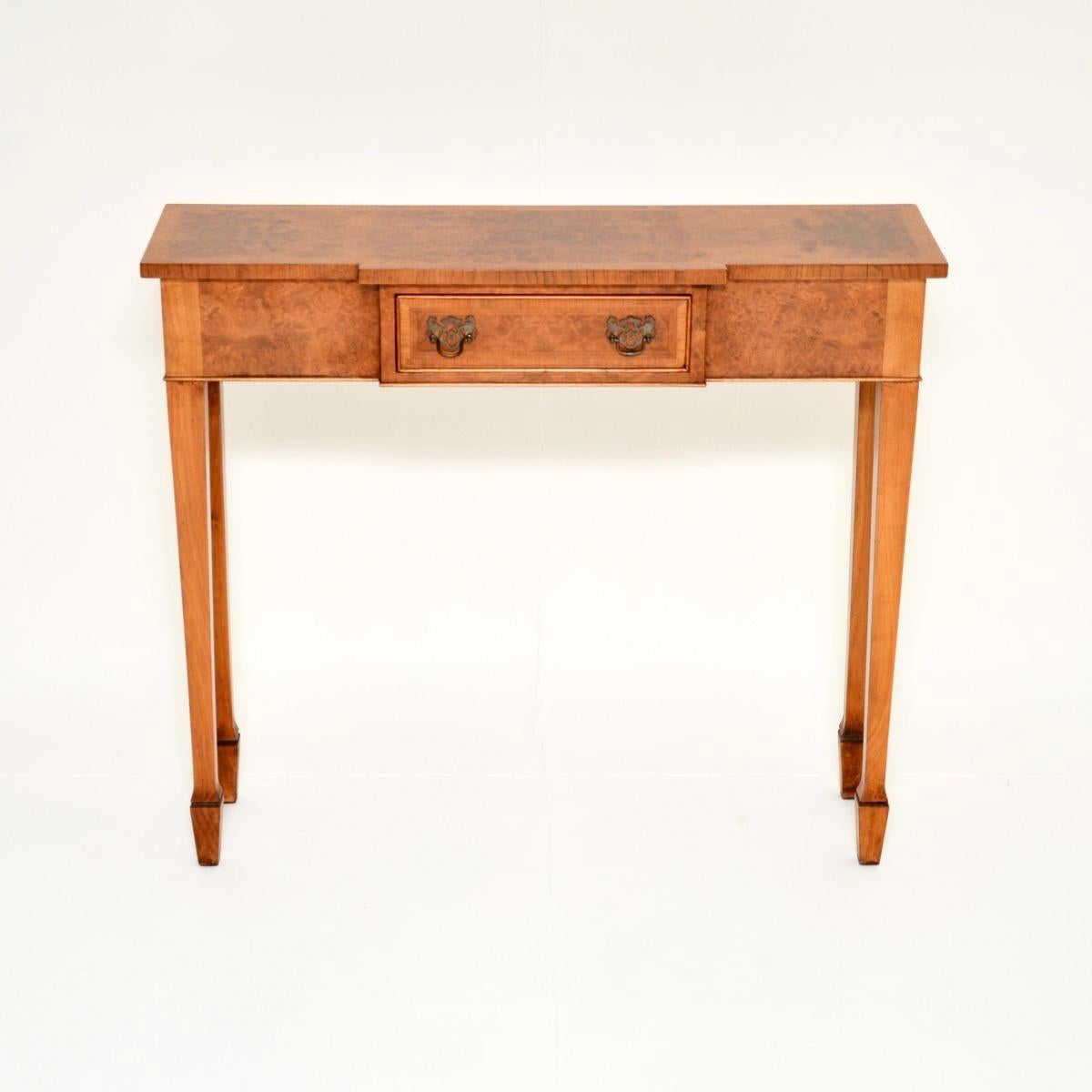 A smart and very well made antique inlaid walnut console side table, in the Georgian style. This was made in England, it dates from around the 1930’s.

It is of outstanding quality and is a very useful, slim size with a breakfront design. The walnut