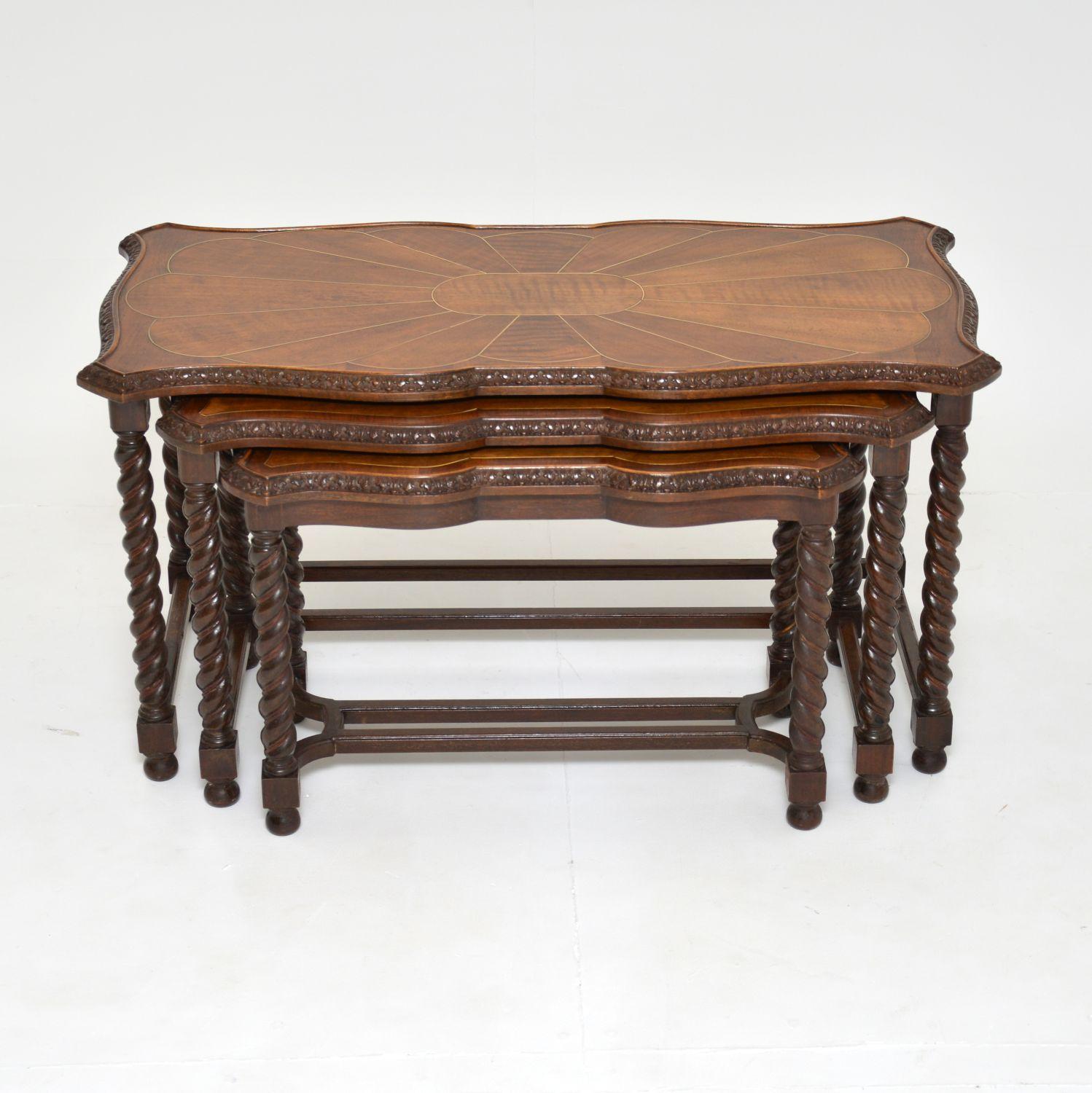 A very unusual and incredibly well made antique nesting coffee table. This was made in England, it dates from around the 1910-20’s.

This has a very useful design, and the quality is amazing. The serpentine shaped edges have crisp and intricate