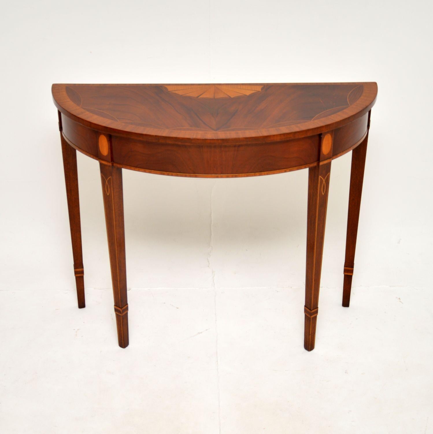 A stunning antique inlaid walnut Sheraton style console table. This was made in England, it dates from around the 1950’s. It actually came from the Ritz hotel in London, it still has the label underneath.

The quality is superb, this is beautifully