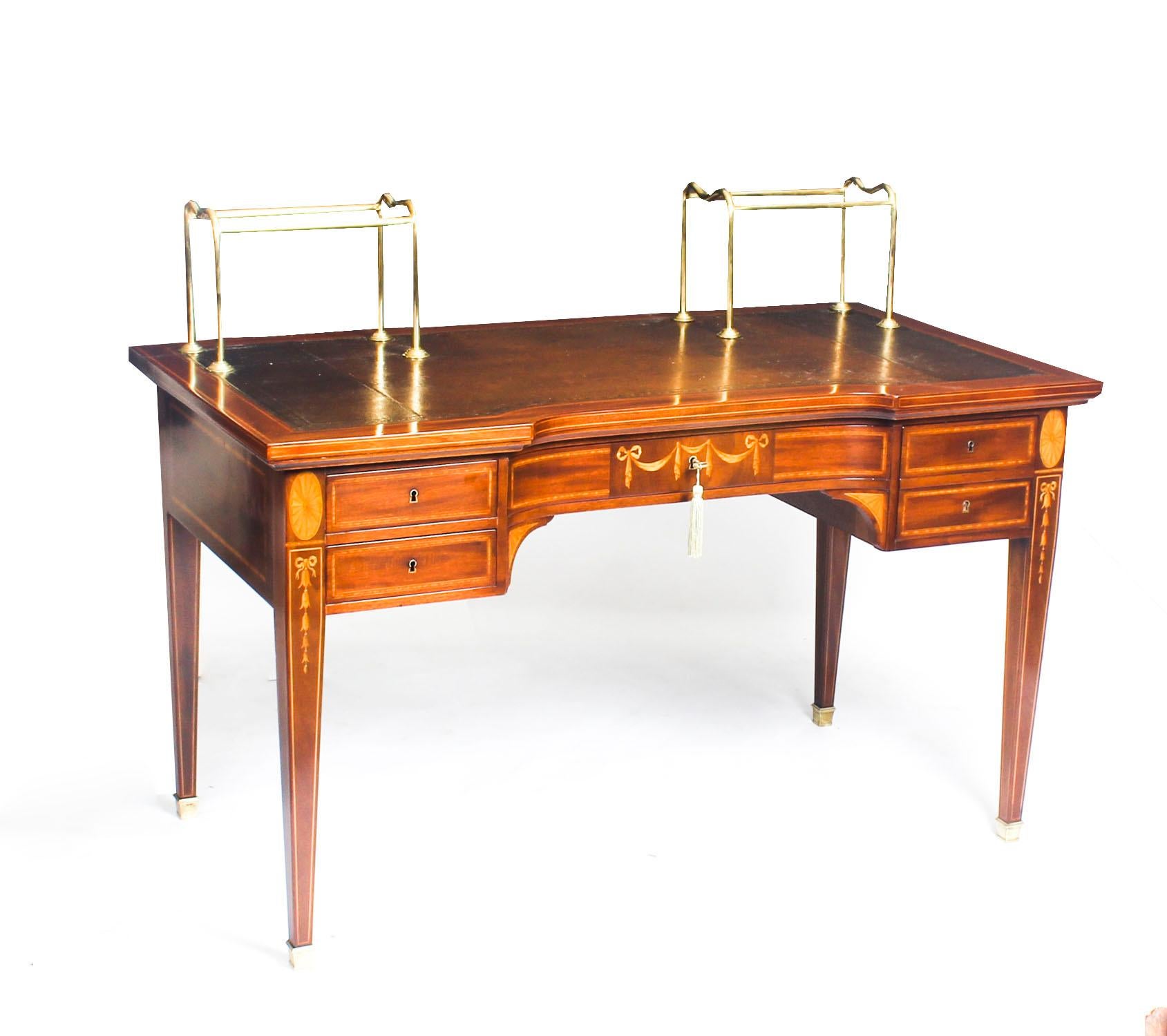 This is a stunning antique writing desk which is crafted from the most beautiful mahogany with fabulous inlaid marquetry decoration, circa 1880 in date.

It has been wonderfully inlaid by a master craftsman with garlands, bell flowers and shells.