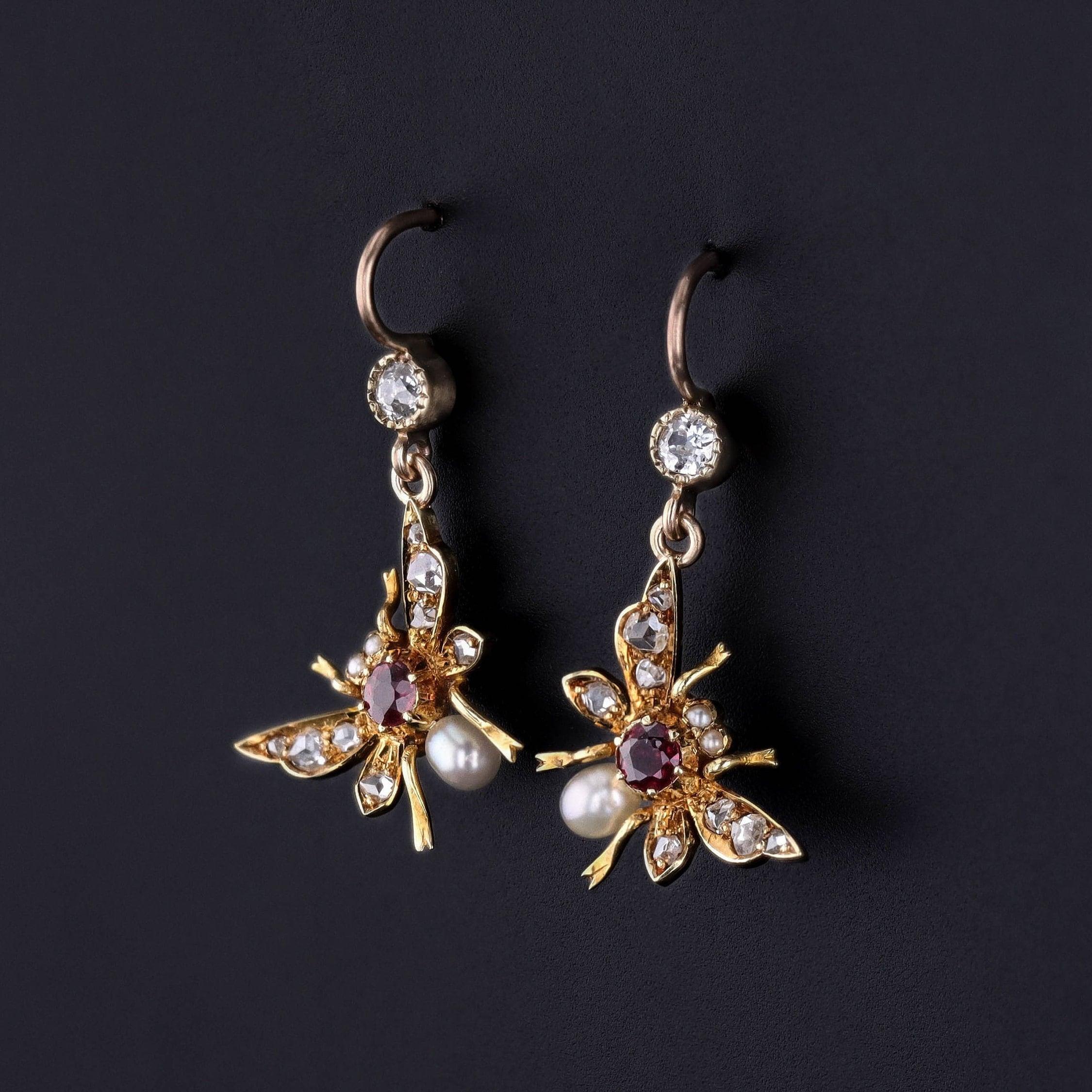These attention grabbing earrings feature insects of rubies, pearls and diamonds set in 15ct gold. The insects were originally part of an antique bar pin (circa 1910) that our jeweler transformed by adding 14k gold ear wires and diamond