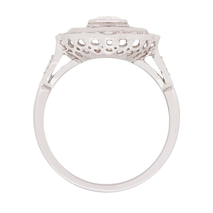 A border of rich, red rubies encircles the sparkling round brilliant cut diamond ‘bullseye’ at the centre of this faithful recent rendition of an antique diamond and ruby target ring.

At the outer edge, a twinkling border of grain set round