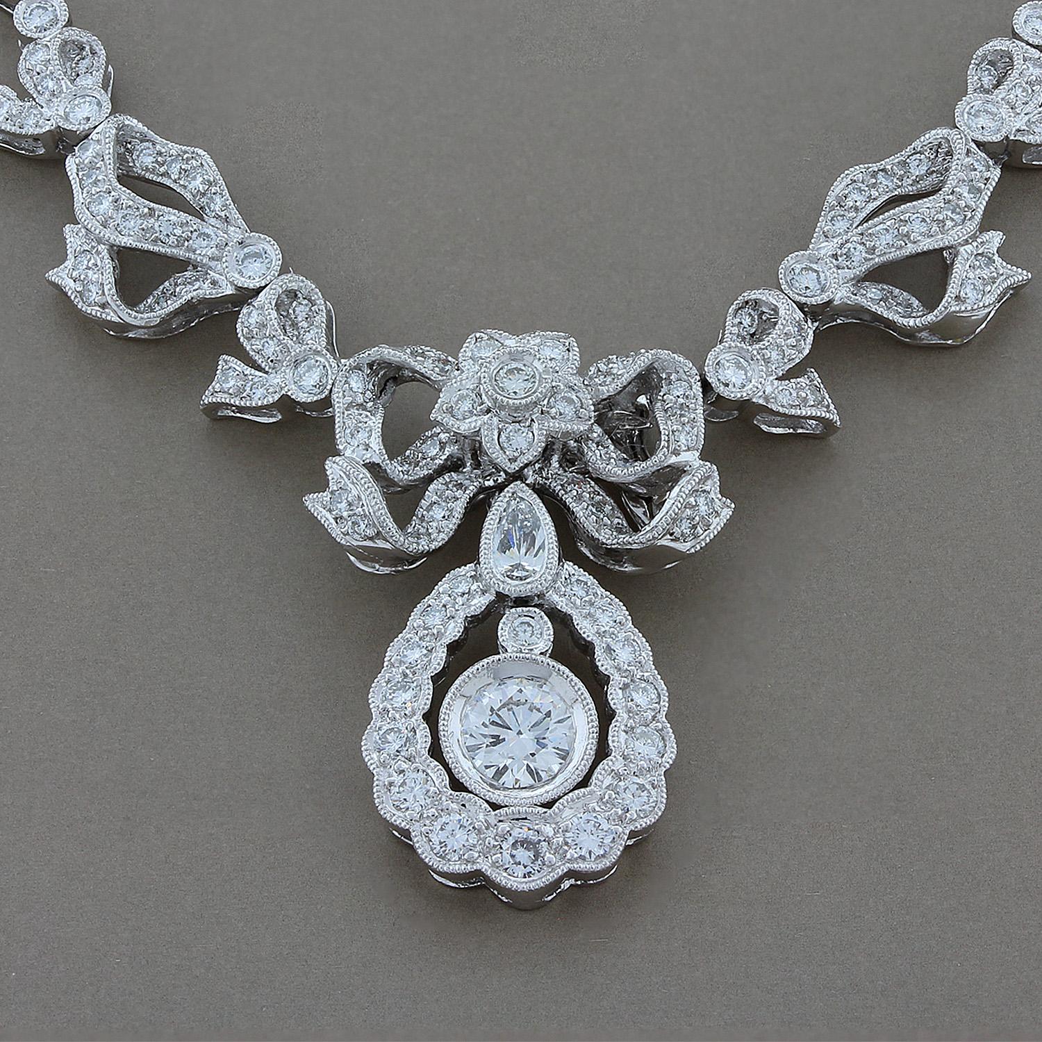 A lovely necklace designed with influences from the Edwardian Era, with detailed filigree and milgrain settings. The necklace features a 0.55 carat round cut diamond with VVS clarity and E-F color, top top grades, with 3.12 carats of smaller