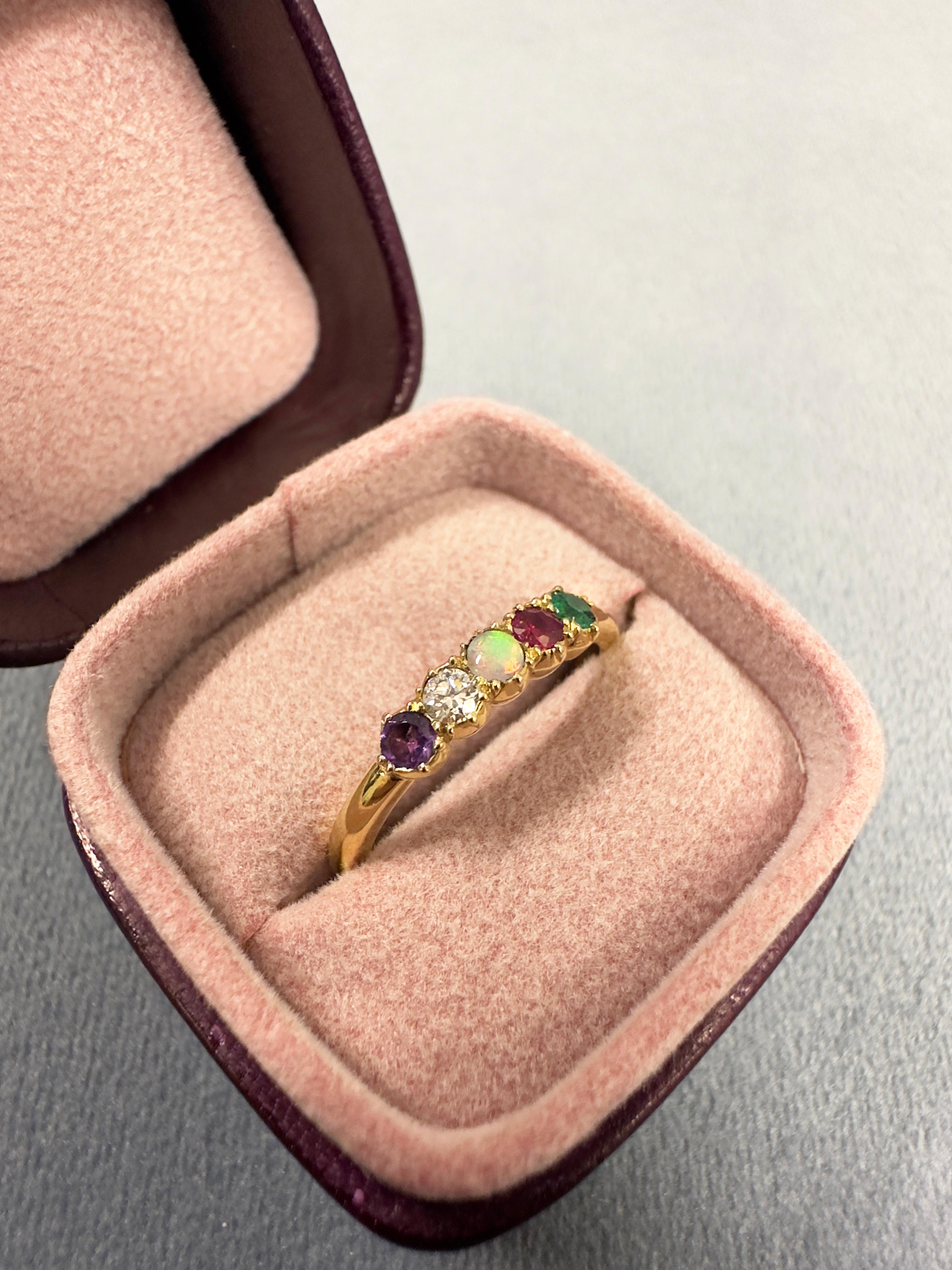 Dieser sehr hübsche Ring verbirgt eine geheime Akrostichon-Botschaft, d.h. der erste Buchstabe eines jeden Edelsteins steht für ein Wort. In diesem Fall sind es ein Amethyst, ein Diamant, ein Opal, ein Rubin und ein Smaragd, die das Wort 