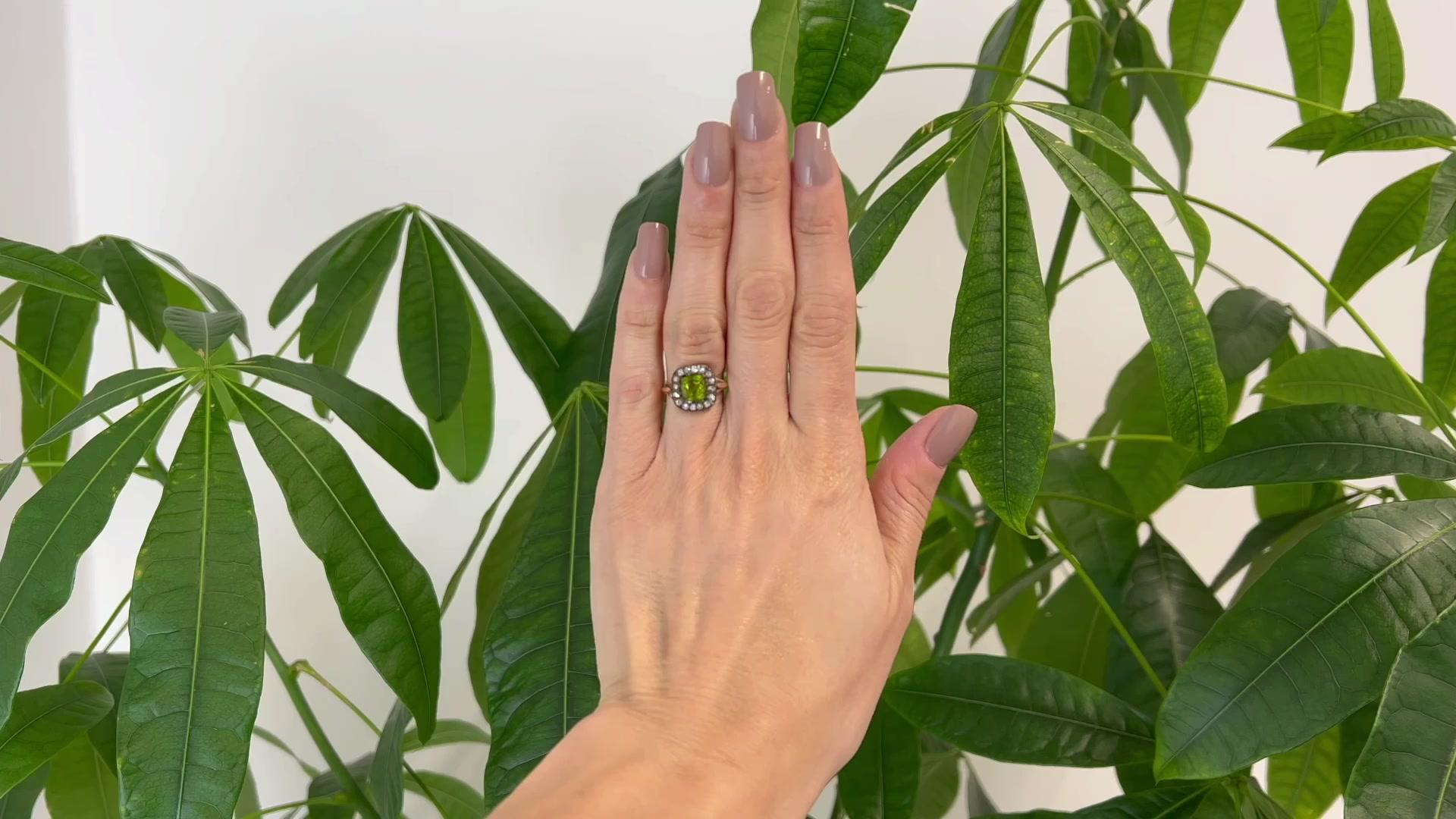 One Antique Inspired Peridot Diamond Silver 14 Karat Rose Gold Ring. Featuring one cushion mixed cut peridot weighing approximately 1.75 carats. Accented by 16 single cut diamonds with a total weight of approximately 0.25 carat, graded I color, SI