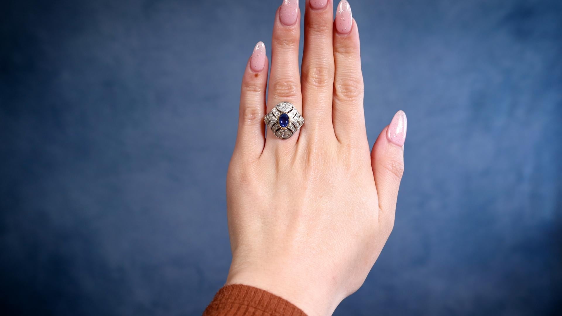 One Antique Inspired Sapphire and Diamond 10k Rose Gold Silver Ring. Featuring one oval mixed cut sapphire weighing approximately 0.90 carat. Accented by 42 round brilliant cut diamonds with a total weight of approximately 0.35 carat, graded