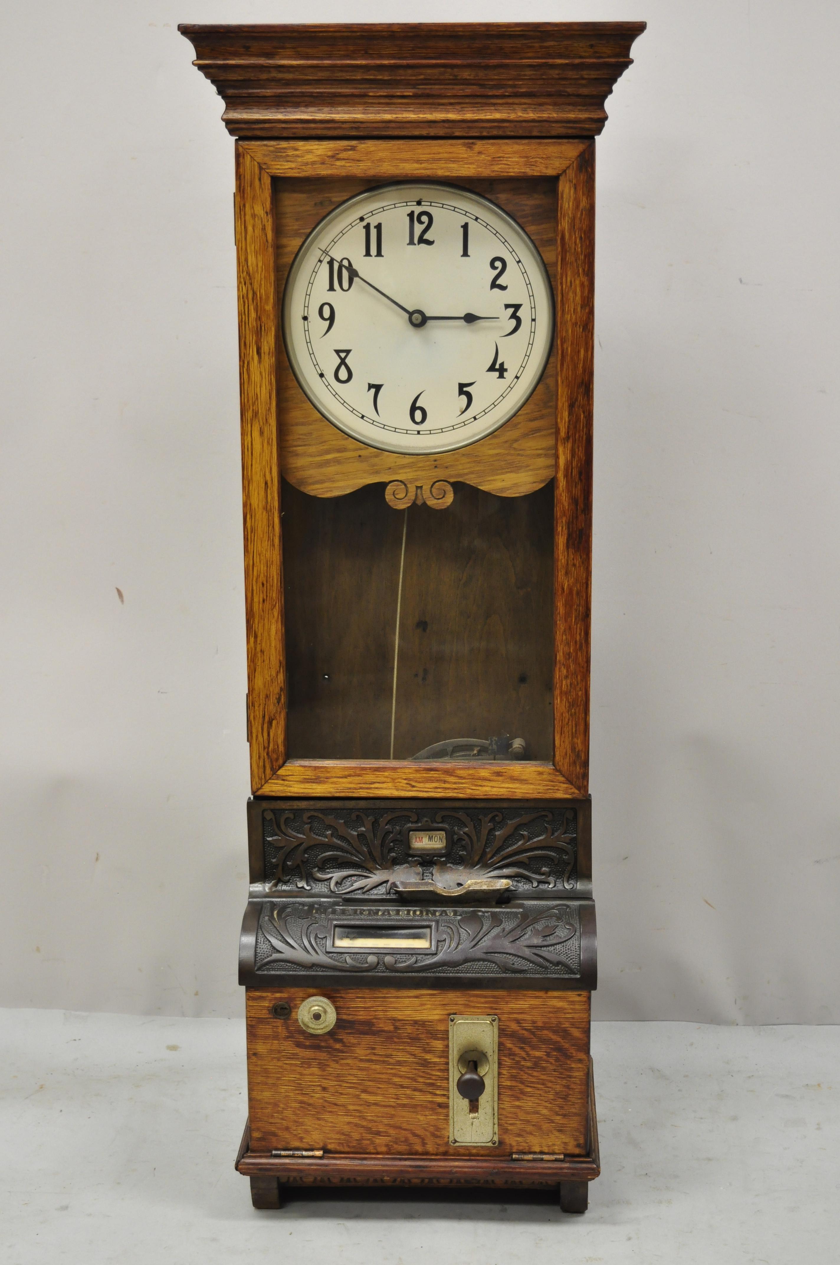 Antique International Time Recording Co. Golden oak wood wall mount time clock. Item features cast iron 