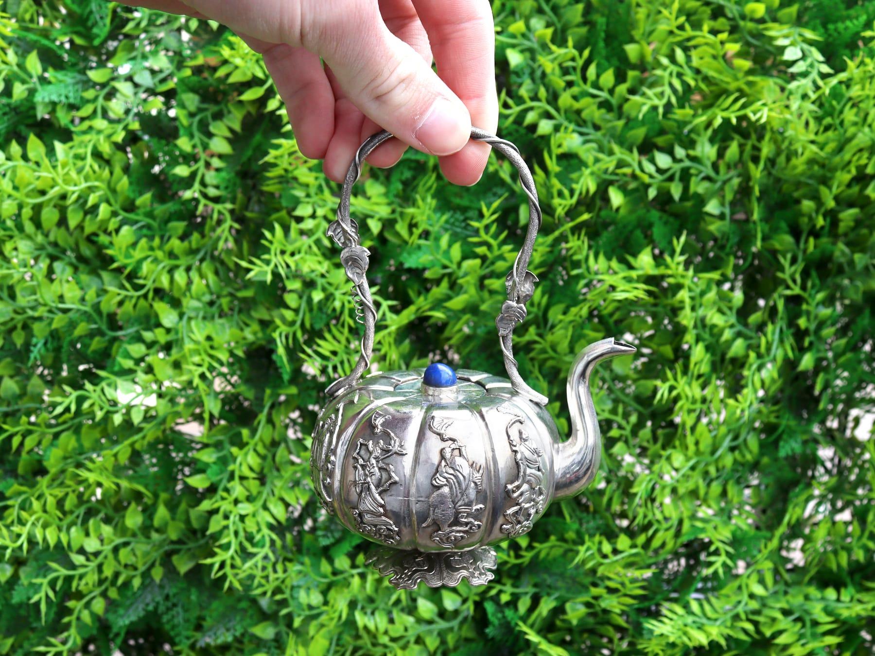 A fine and impressive antique Iraqi silver teapot; an addition to our diverse Asian teaware collection.

This fine antique Iraqi silver miniature teapot has a pumpkin shaped form onto a shaped cinquefoil foot.

Each panel of the body is