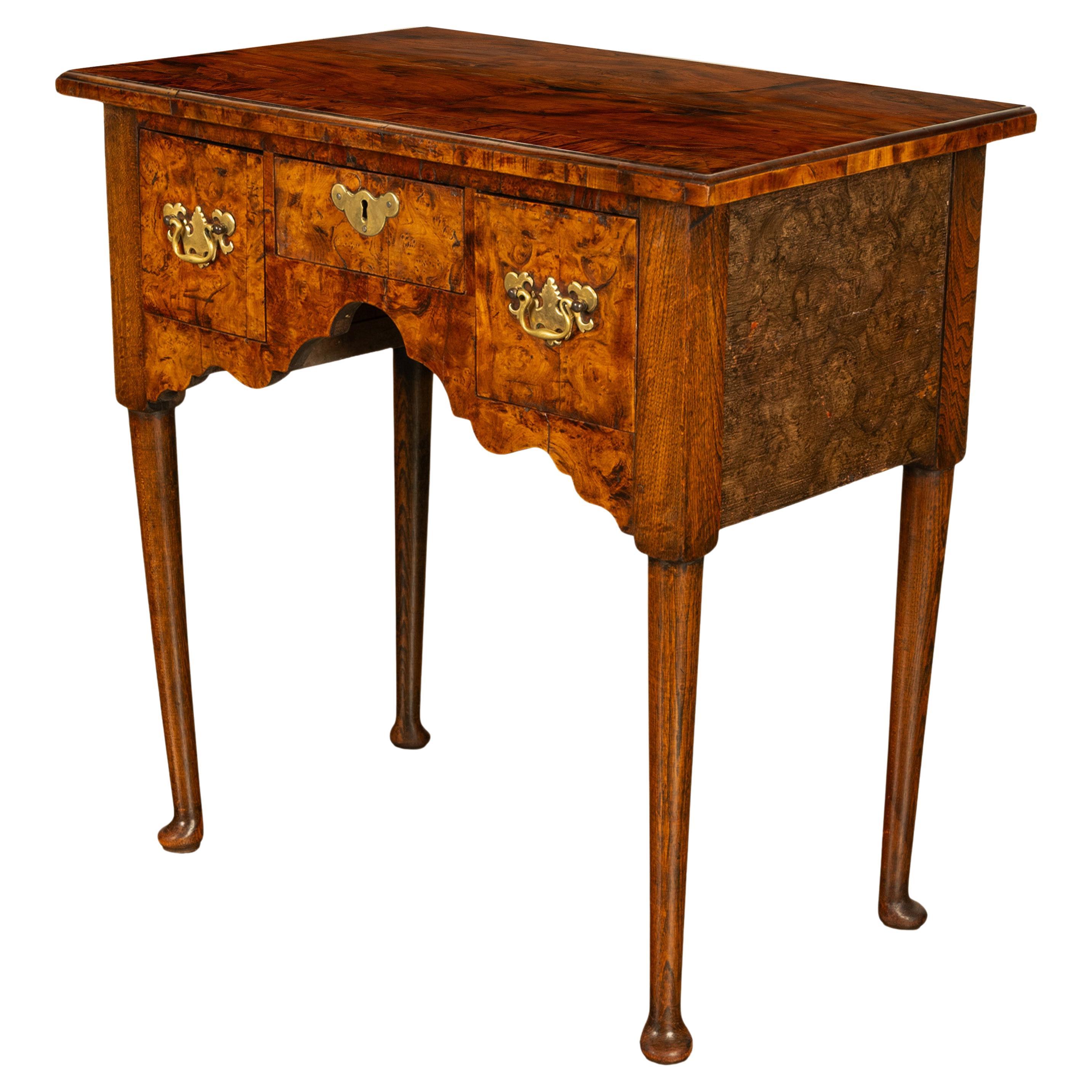 A fine & well proportioned early 18th century George I antique Irish walnut & burl lowboy, circa 1720.
The overhanging top having quartered burl walnut and is edgebanded, below are three drawers that are nicely hand dovetailed. There are two deep