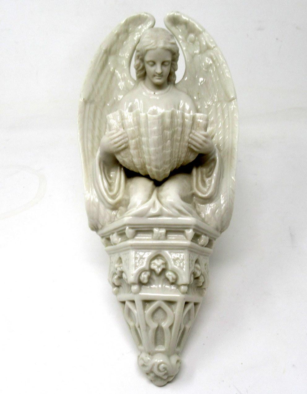 An extremely rare early Irish Belleek porcelain wall angel good size holy water font of outstanding quality and good condition. 

Second period black mark for 1891-1926. 

Modelled as a large winged Angel kneeling on a Gothic corbel, holding a